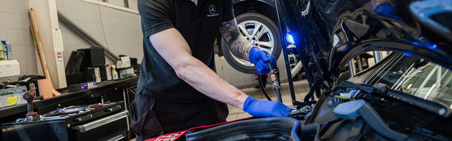 Mercedes-Benz Technician completes under the hood repair on Mercedes-Benz vehicle at Mercedes-Benz Repair Centre