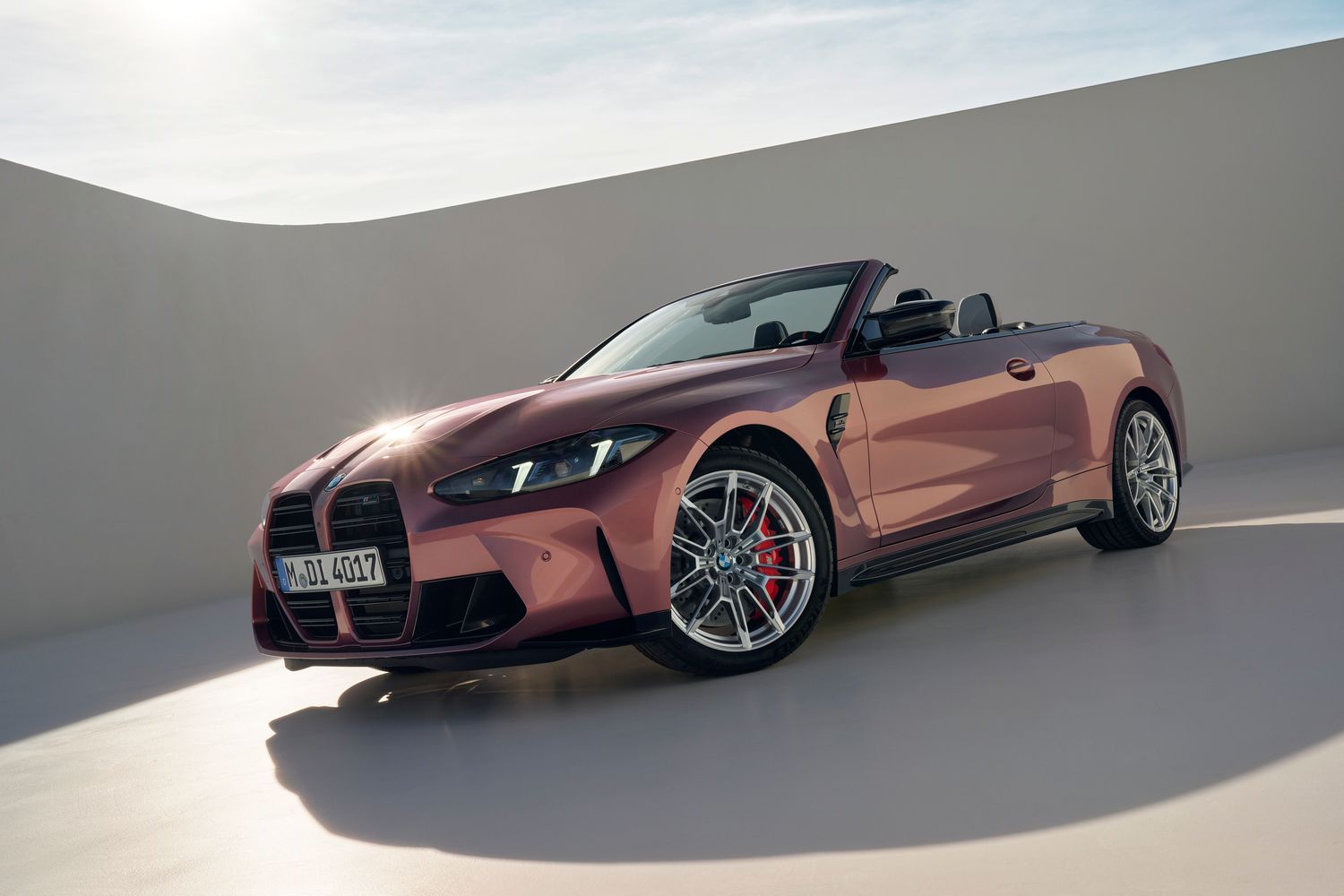 Front and side view of the BMW M4 Competition Convertible in purple, on neutral background