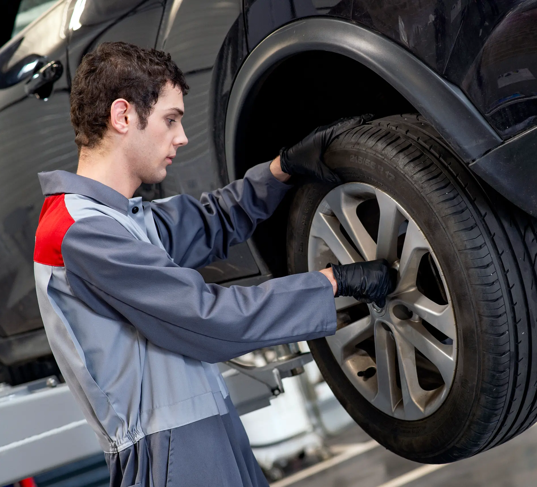 Car Mechanic fitting a wheel