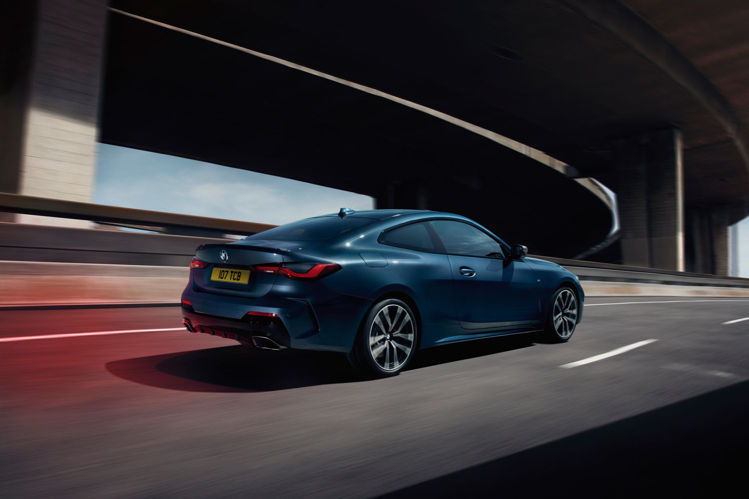Side view of the new BMW 4 Series Coupe. Driving on busy motorway.