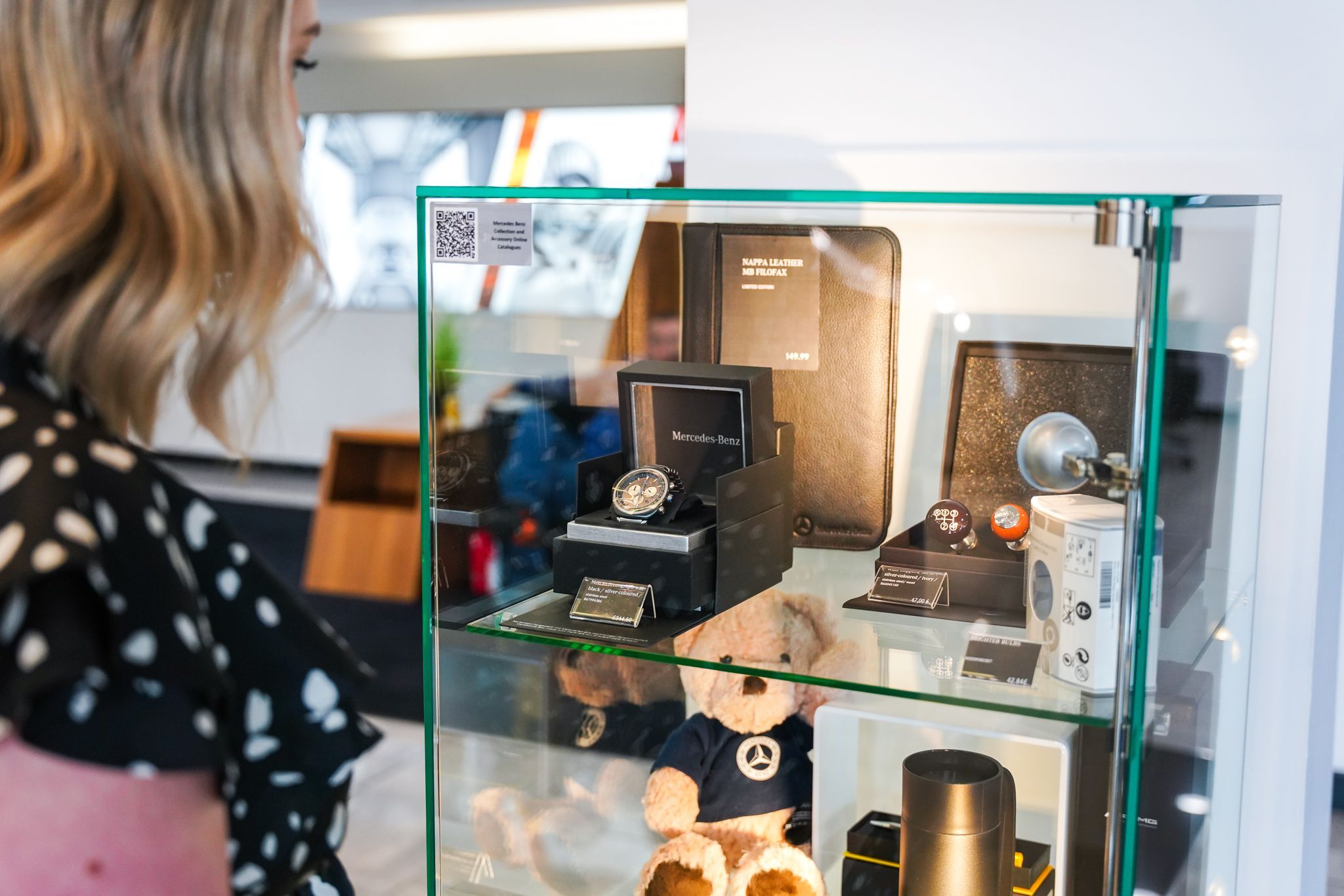 Mercedes-Benz customer looks at the latest Mercedes-Benz accessories and merchandise items available at Mercedes-Benz of Belfast