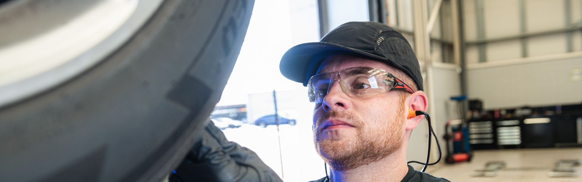 Mercedes-Benz Technician inspects tyre during vehicle repair at the Mercedes-Benz Repair Centre