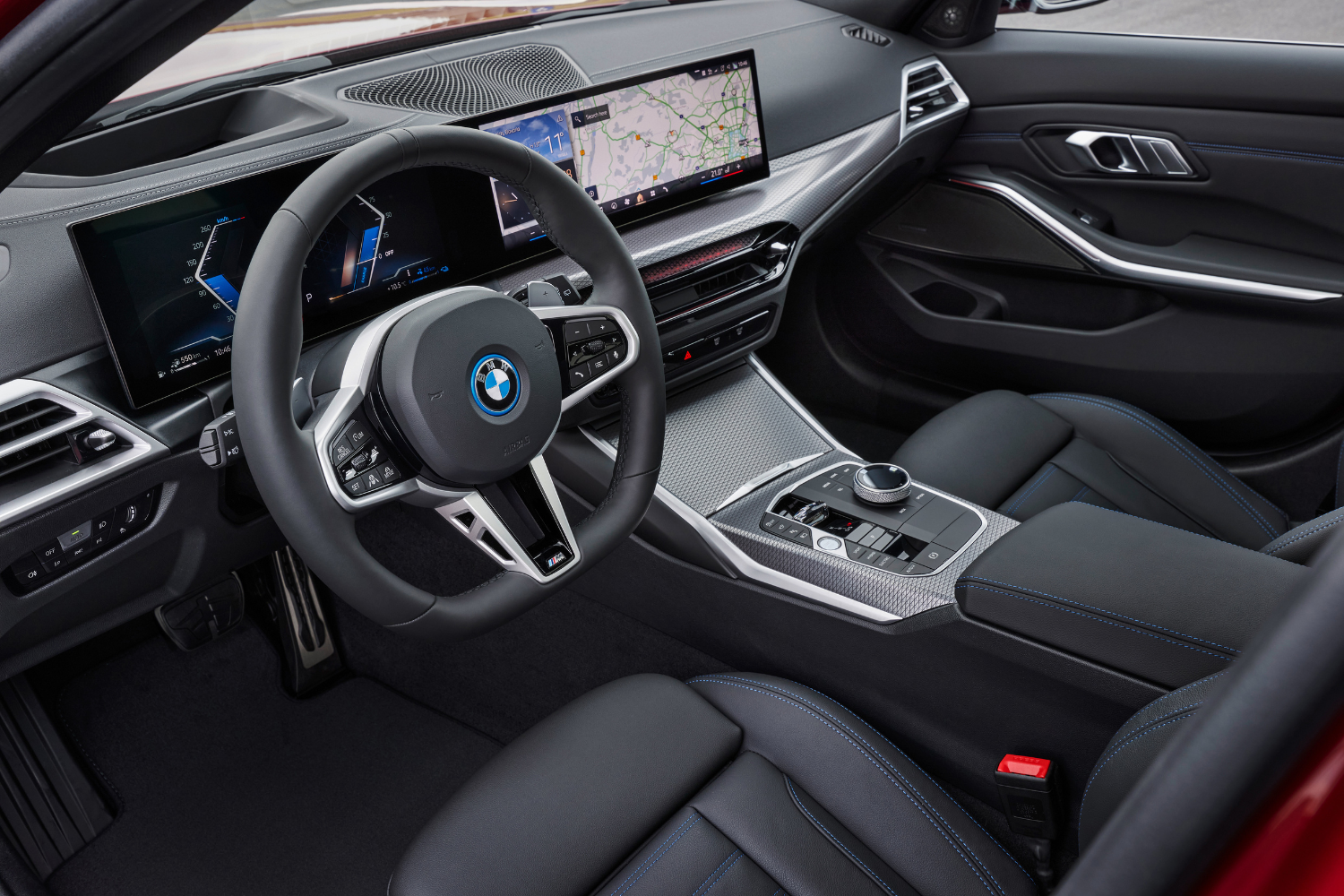Black interior of the new 2024 BMW 3 Series Touring featuring two driver displays.