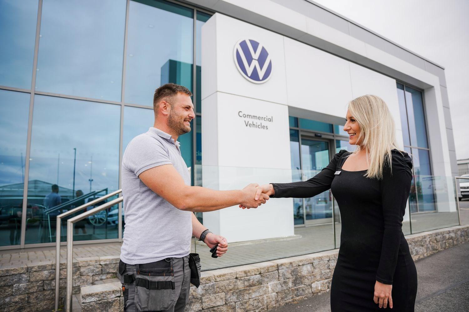 Volkswagen Commercials Sales Specialist shakes customers hand outside of the Agnew Van Centre showroom