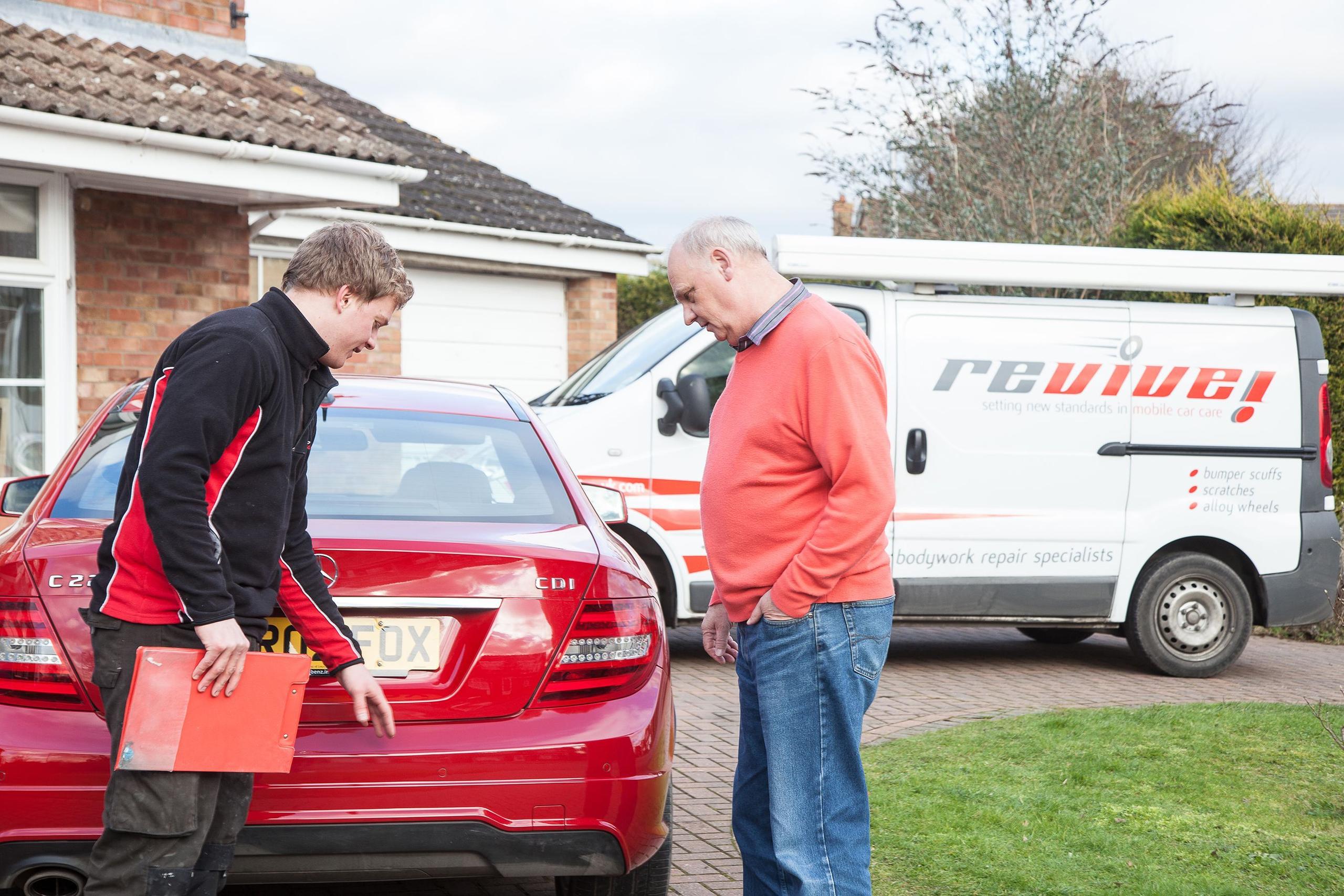 Revive Technician discusses vehicle repair with customer at their home