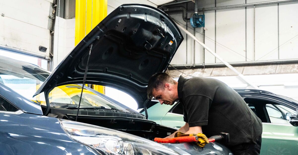 Kia Technician working a a car