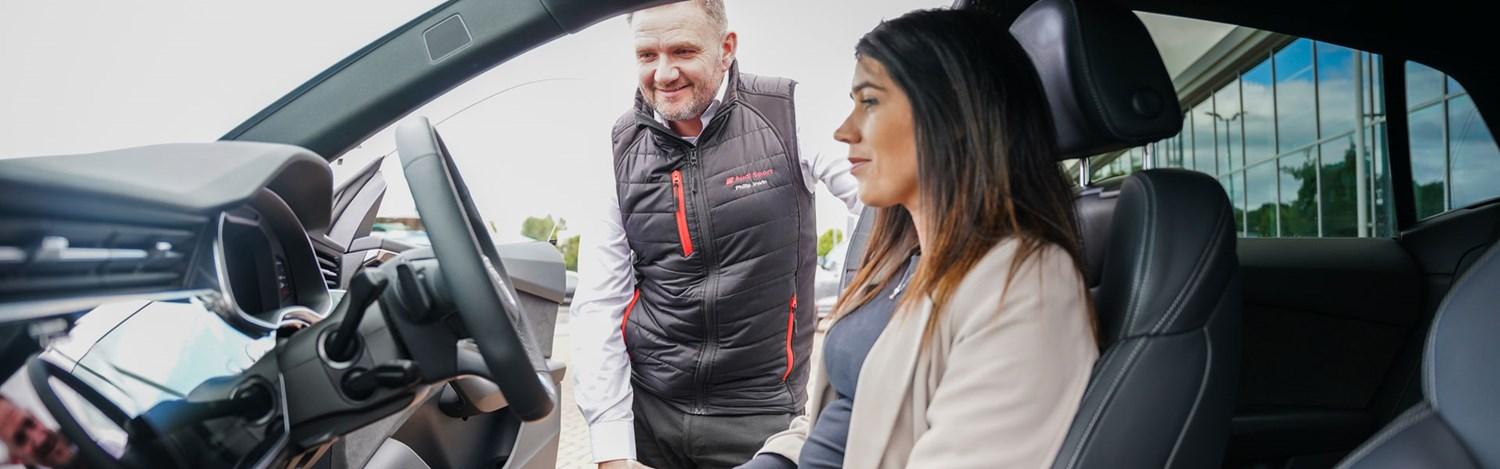 Audi Sales Specialist talks to customer about the key interior features of an Audi A3 at Portadown Audi