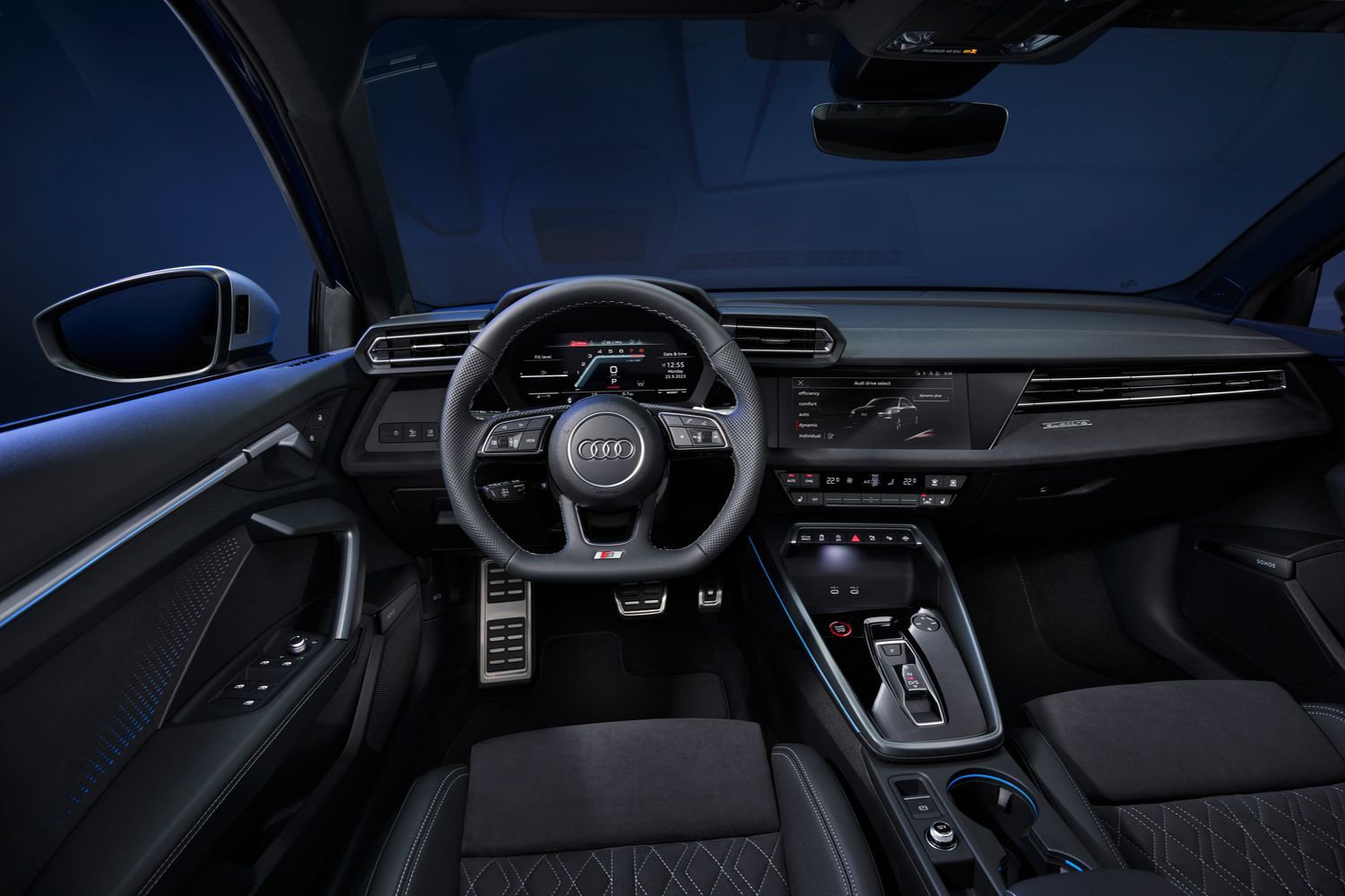 The newly updated Audi S3 Saloon's black interior, steering wheel and two driver displays.