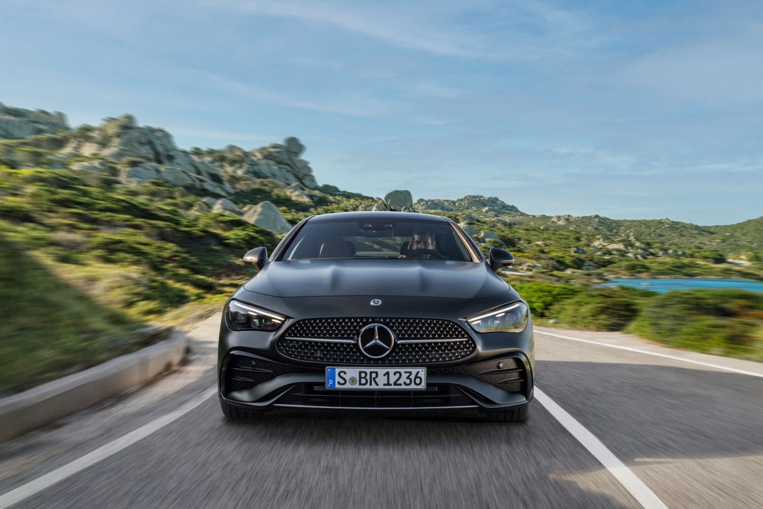 Front view of a black Mercedes-Benz CLE Coupé driving.