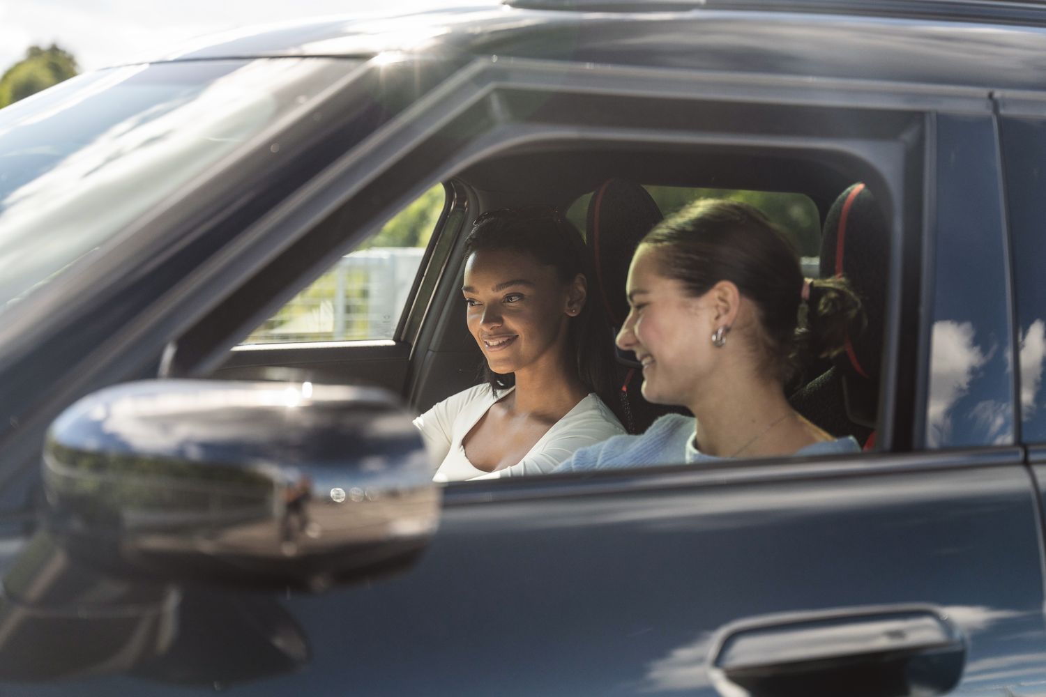 Two friends inside the new all-electric MINI Aceman, trying out the Experience Modes.