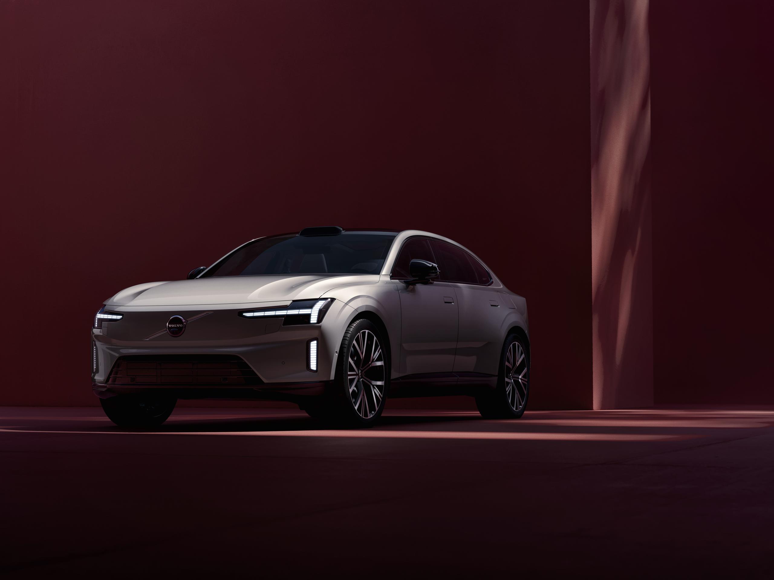 Volvo ES90 parked at red walled car park