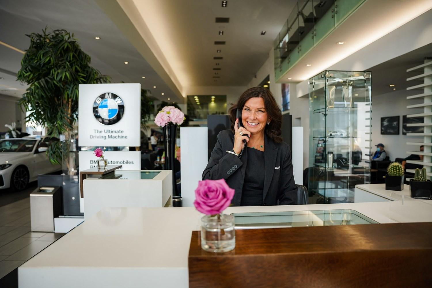 Smiling BMW CRM Team Member arranges a repair booking over the phone with customer at Bavarian BMW Belfast