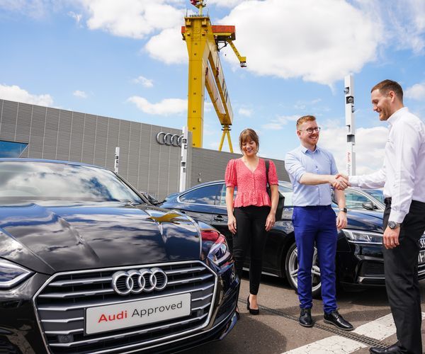 Belfast Audi sales team with a customer