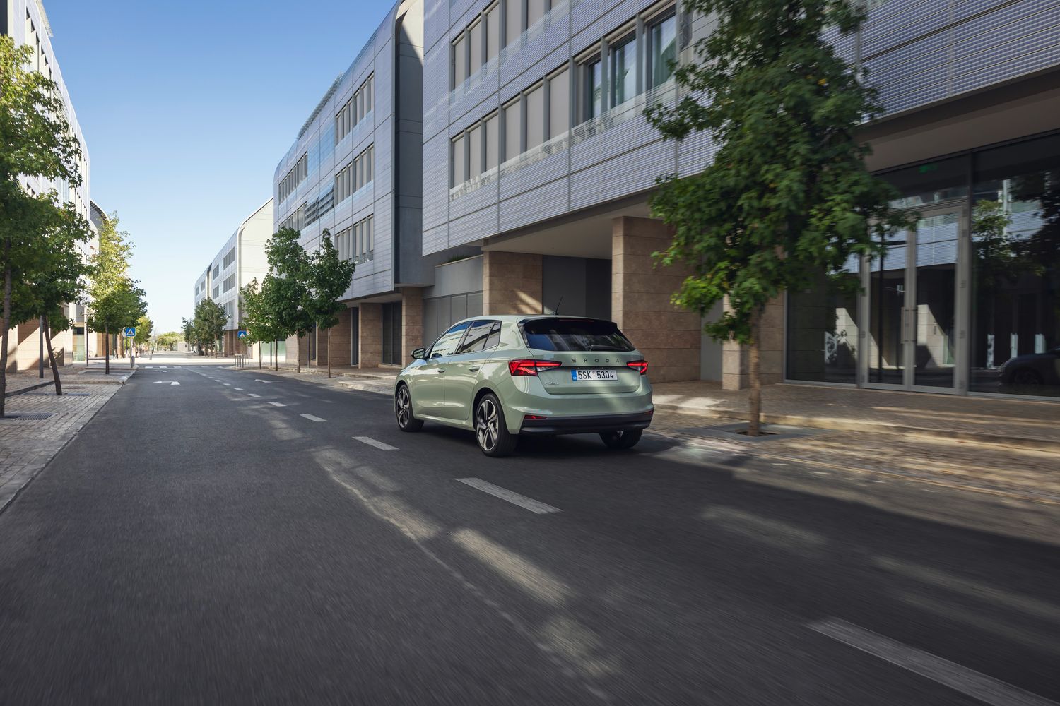 Rear view of the new Skoda Fabia, parked outside shops on busy highstreet.