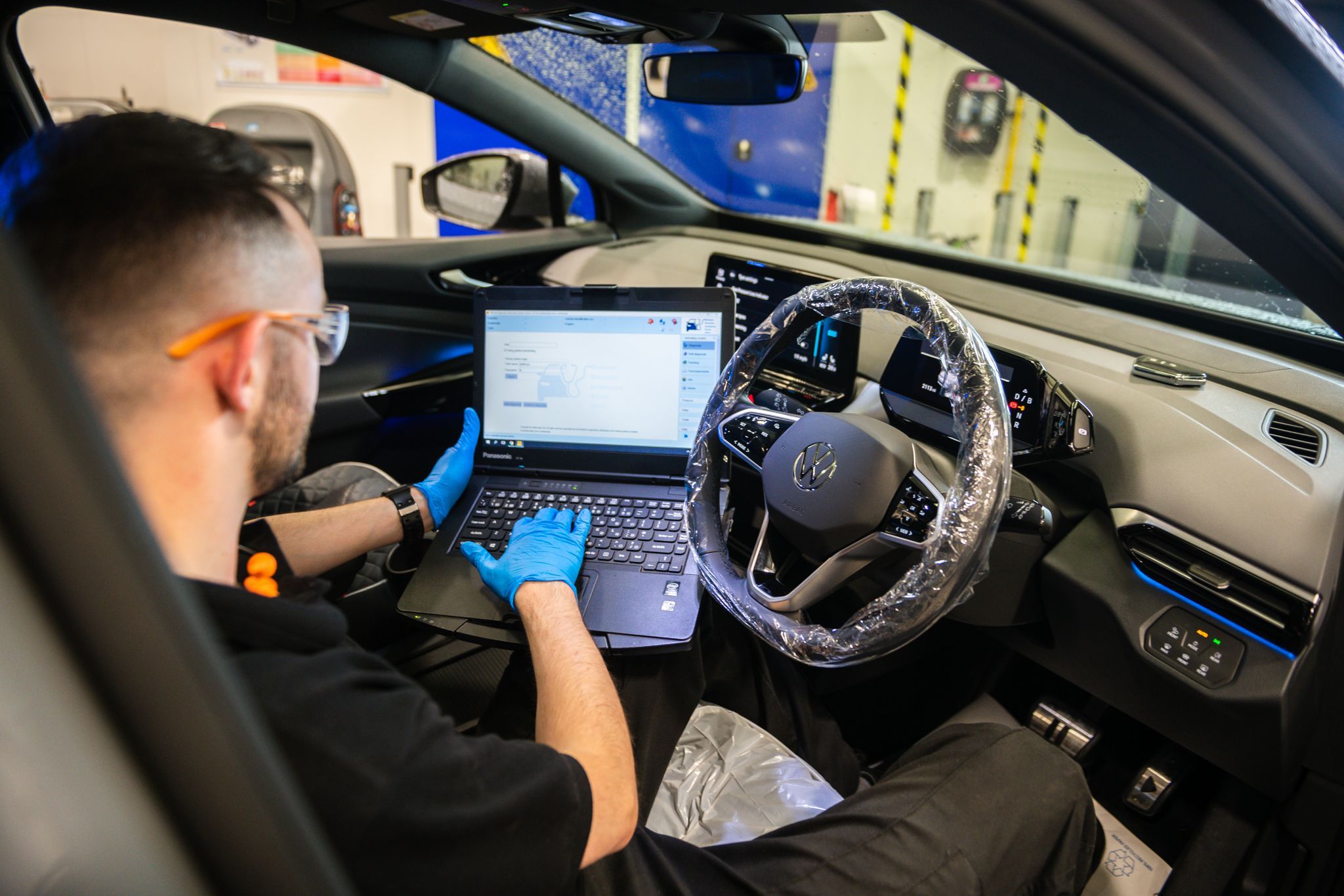Volkswagen Technician inspects batter of Electric vehicle on service plan at Agnew Volkswagen Mallusk