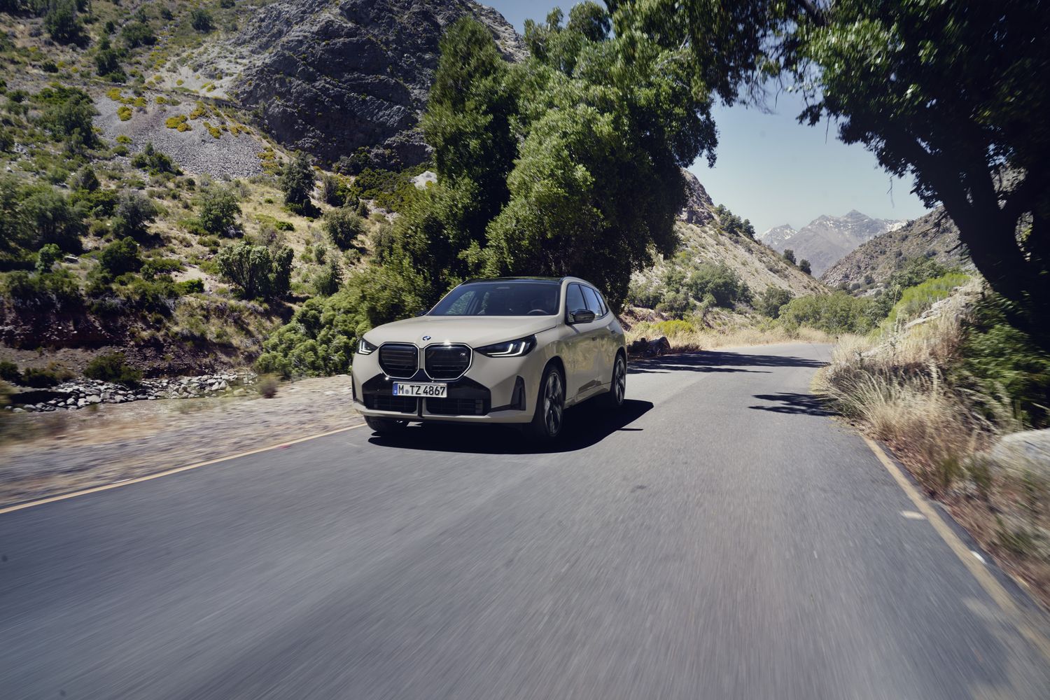 The new BMW X3 driving on country road.