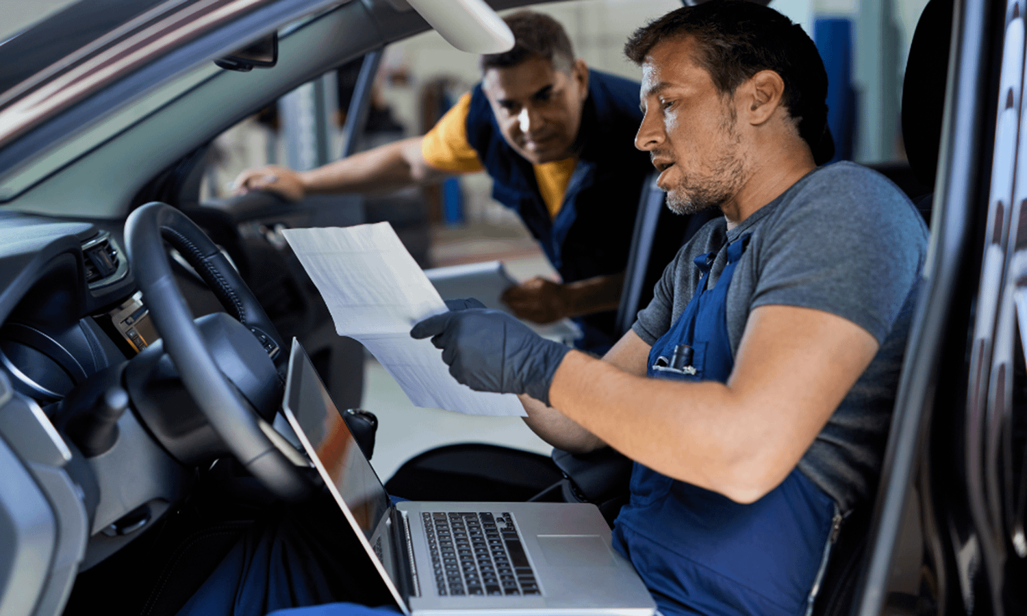 a mechanic diagnosing a fault with a car