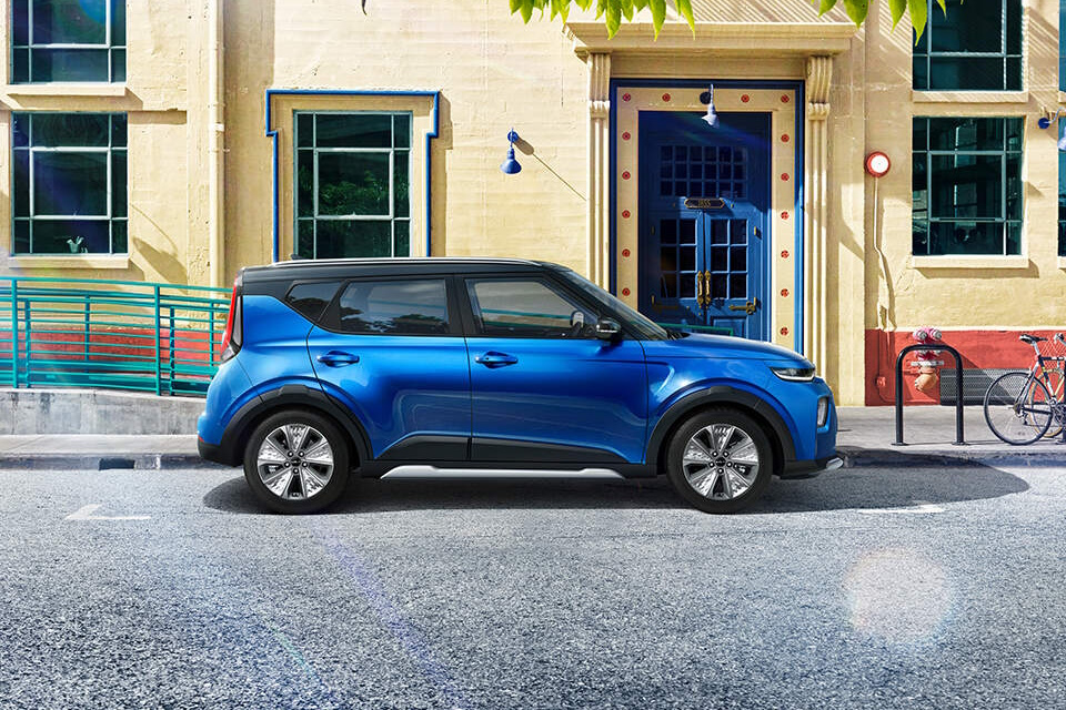 kia soul ev parked by a house
