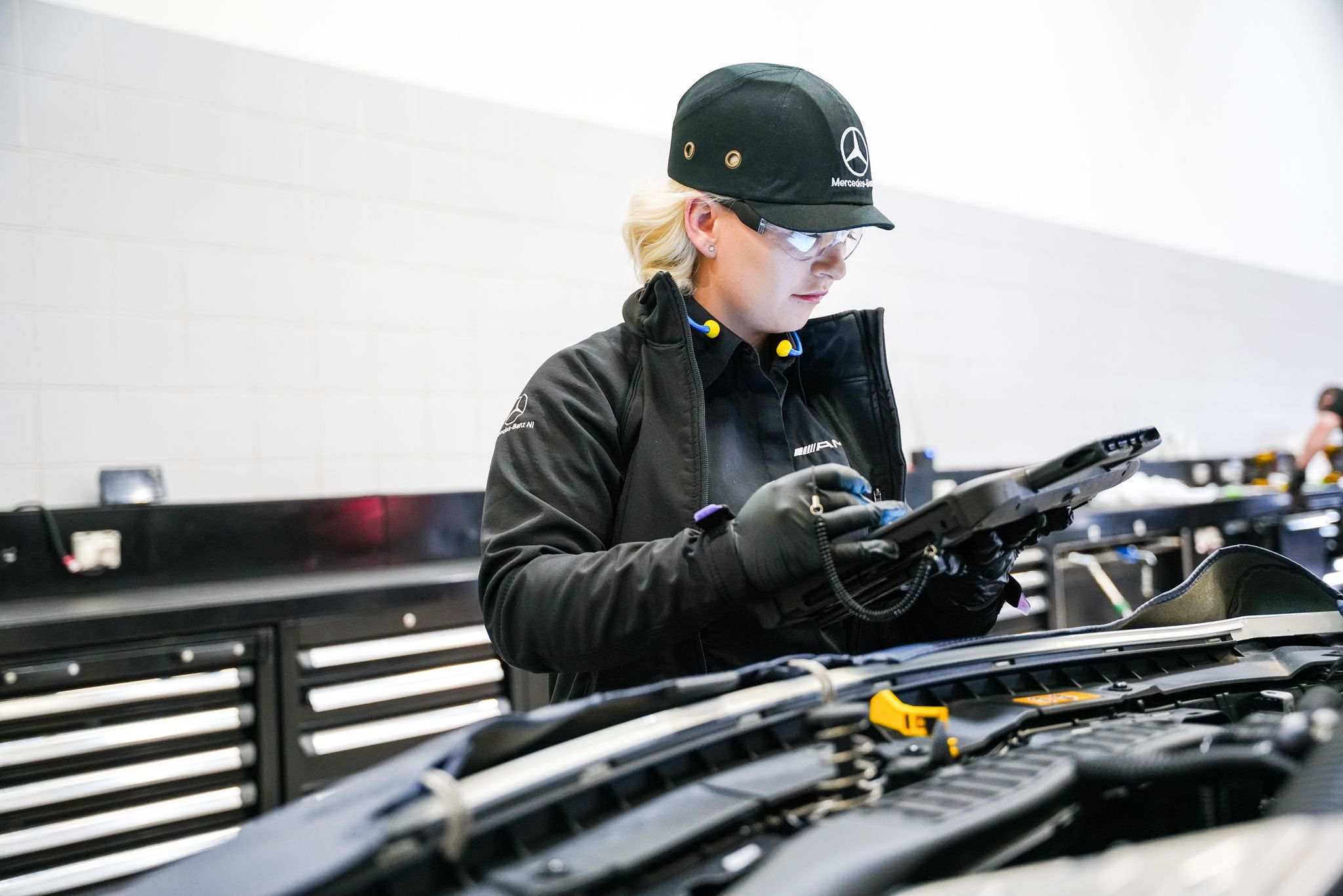 Mercedes-Benz Technician inspects engine of Motability vehicle