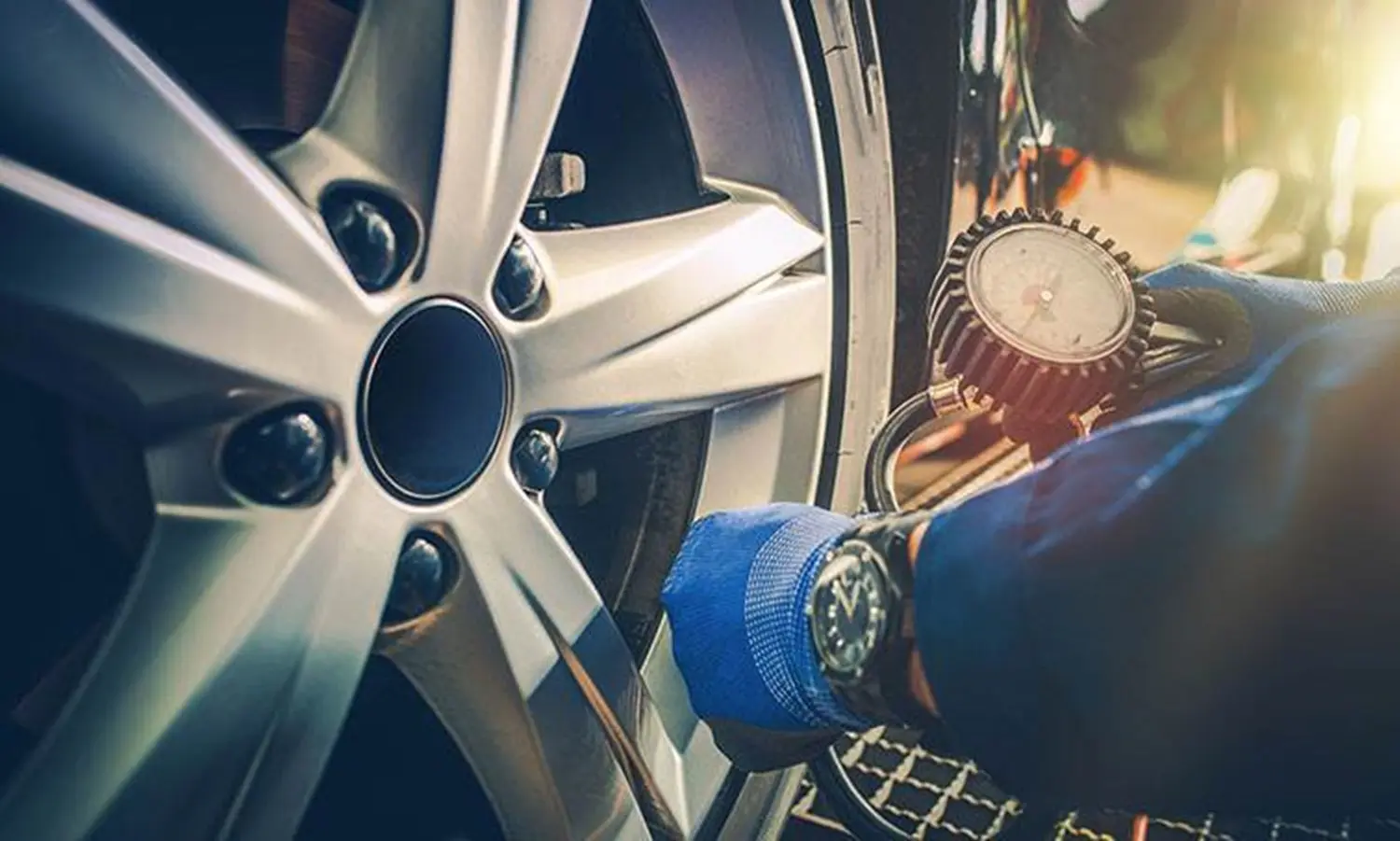 Someone checking tire pressure