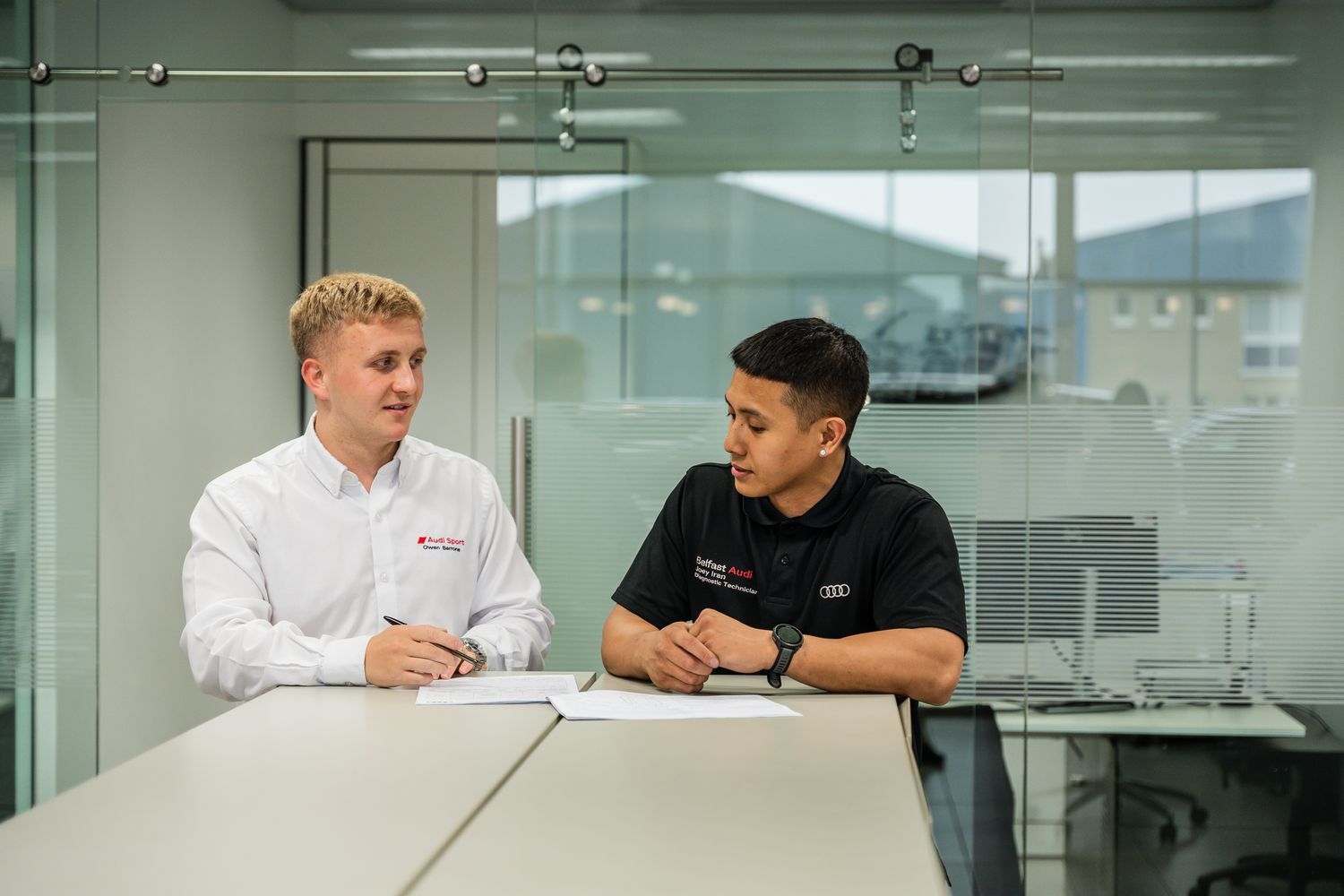 Two Audi Service Advisors discuss issues with vehicle