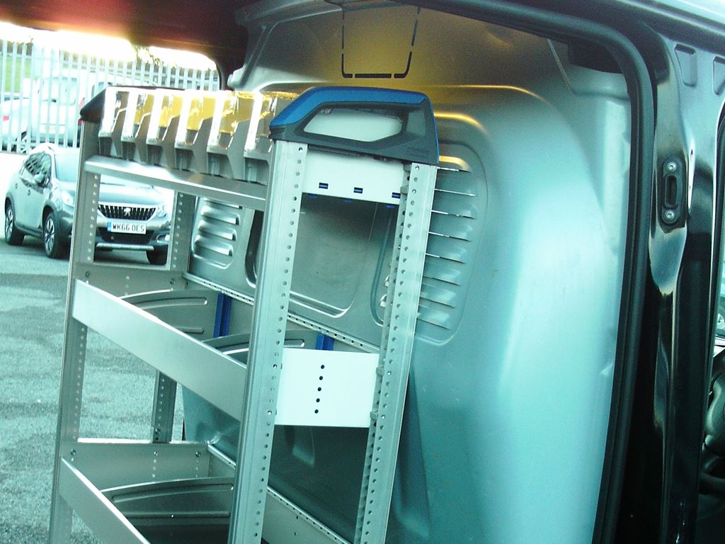Van side opening showing metal racking frame positioned for installation.