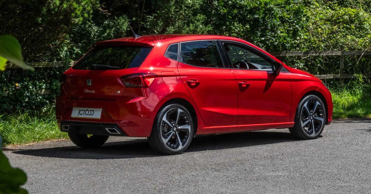 SEAT Ibiza parked in front of trees and bushes