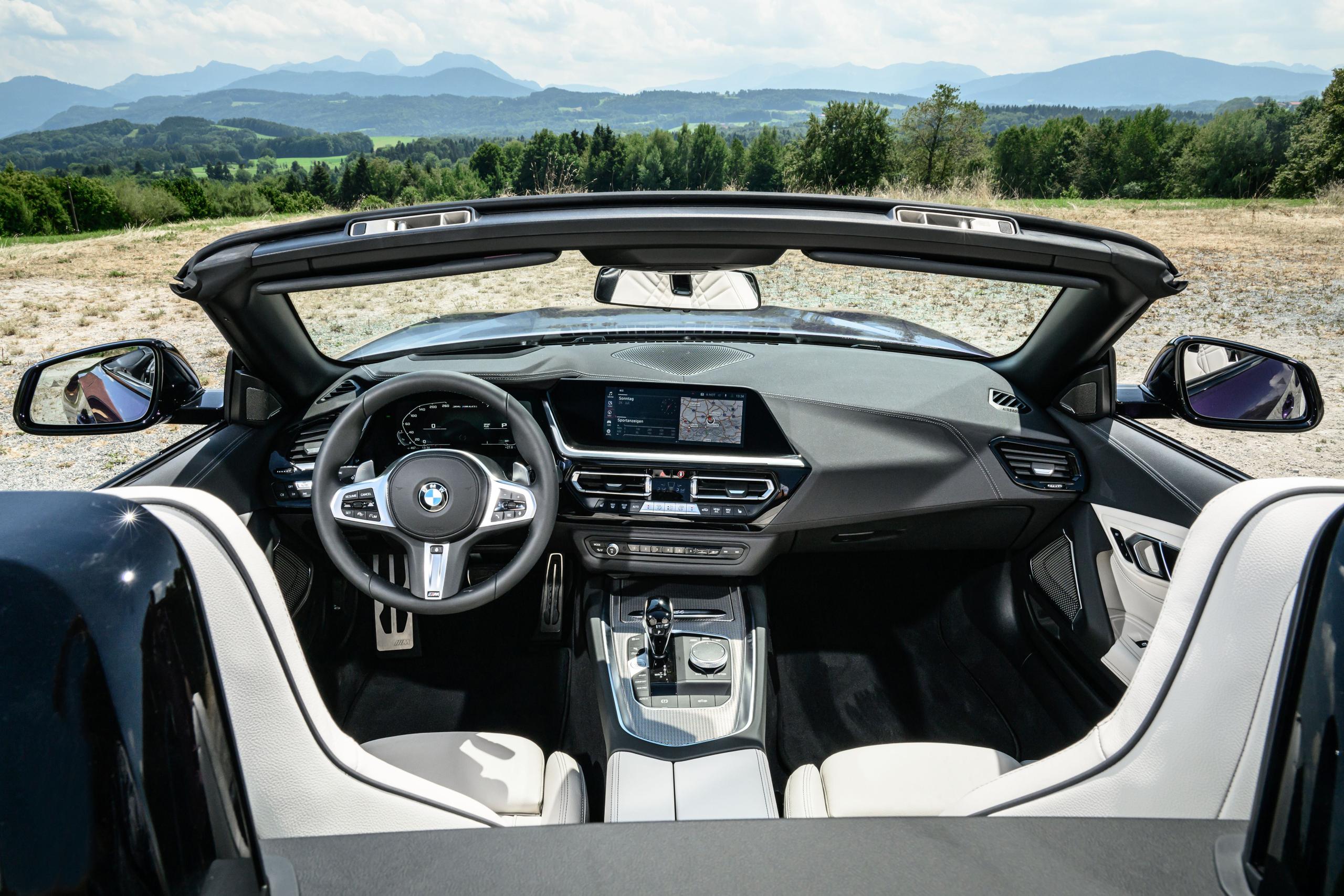 Interior view of new BMW Z4, close-up of steering wheel and infotainment system of vehicle