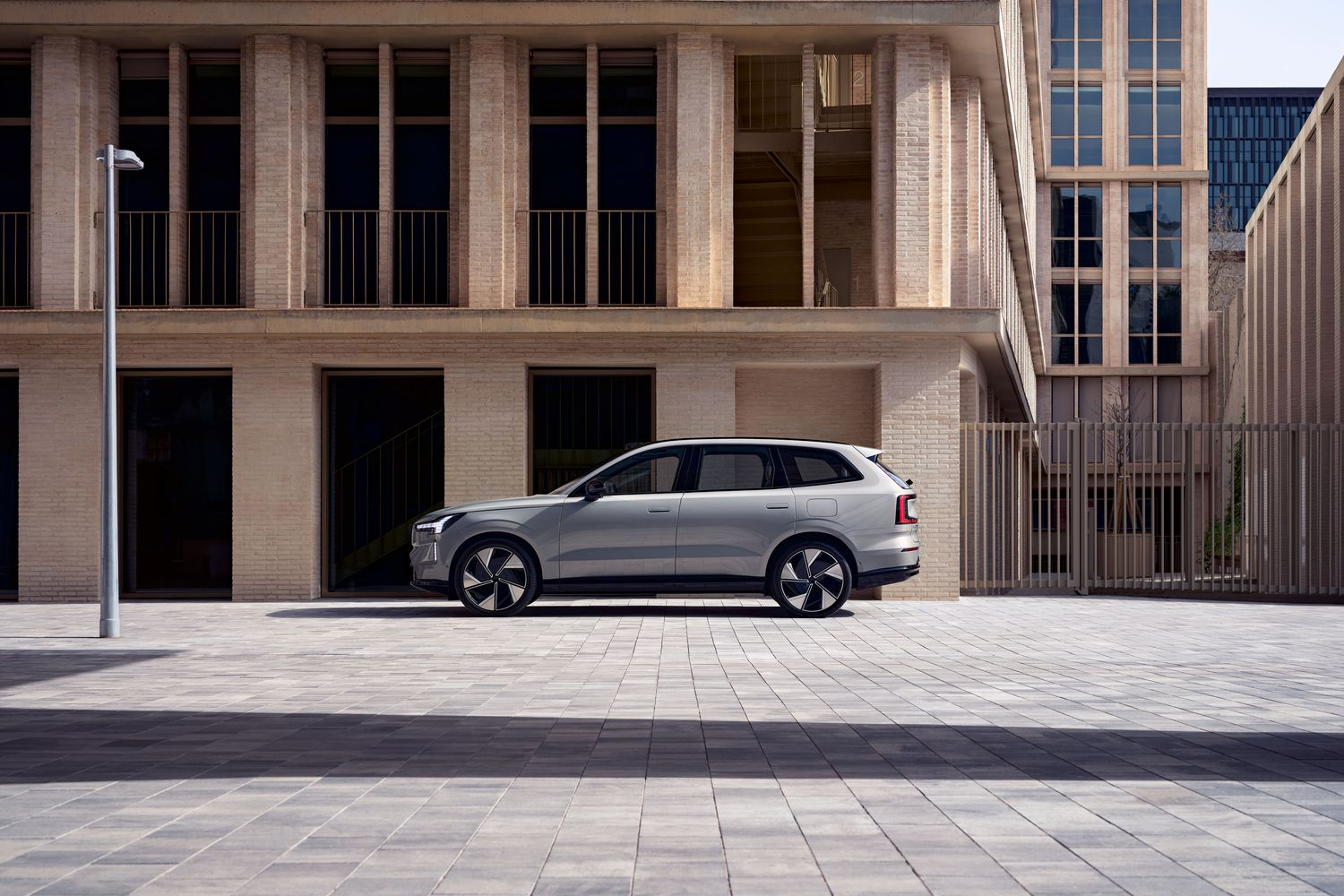 Side view of the Volvo EX90, parked in residential streets.