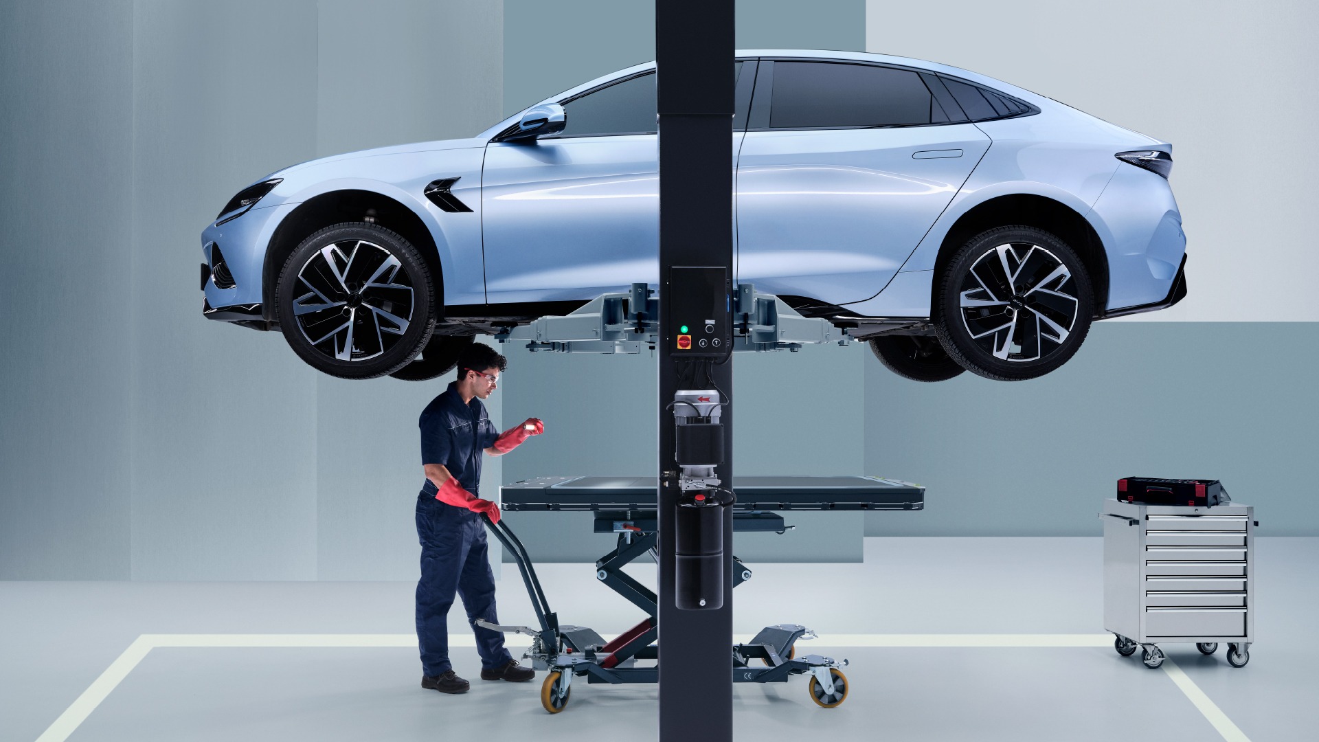 Car on a jack bing fixed by mechanic