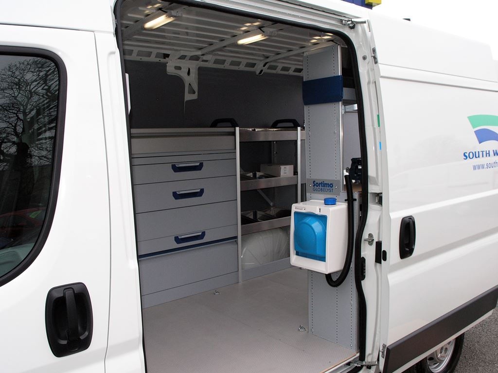 South Water van with side door open, showing fitted drawers, shelving and dispenser unit.