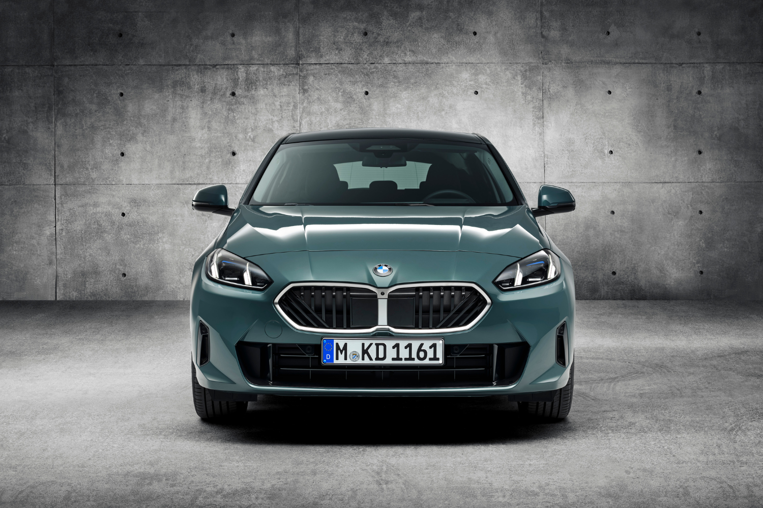 Front view of the newly updated 2024 BMW 1 Series in green.