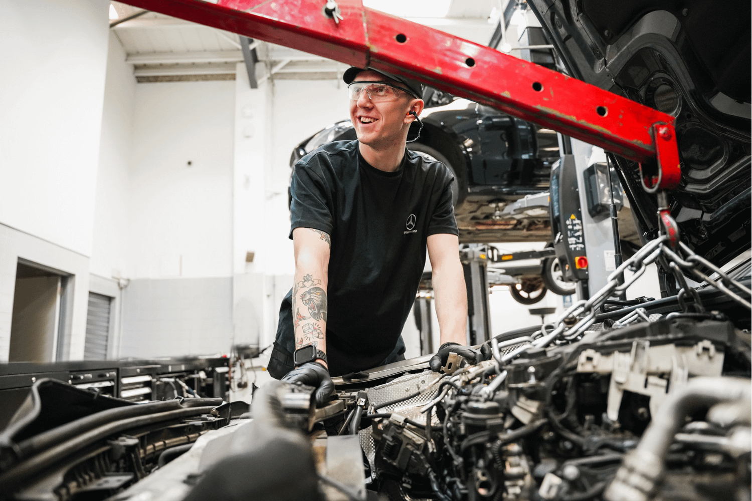 Mercedes-Benz Technician inspects engine during maintenance work
