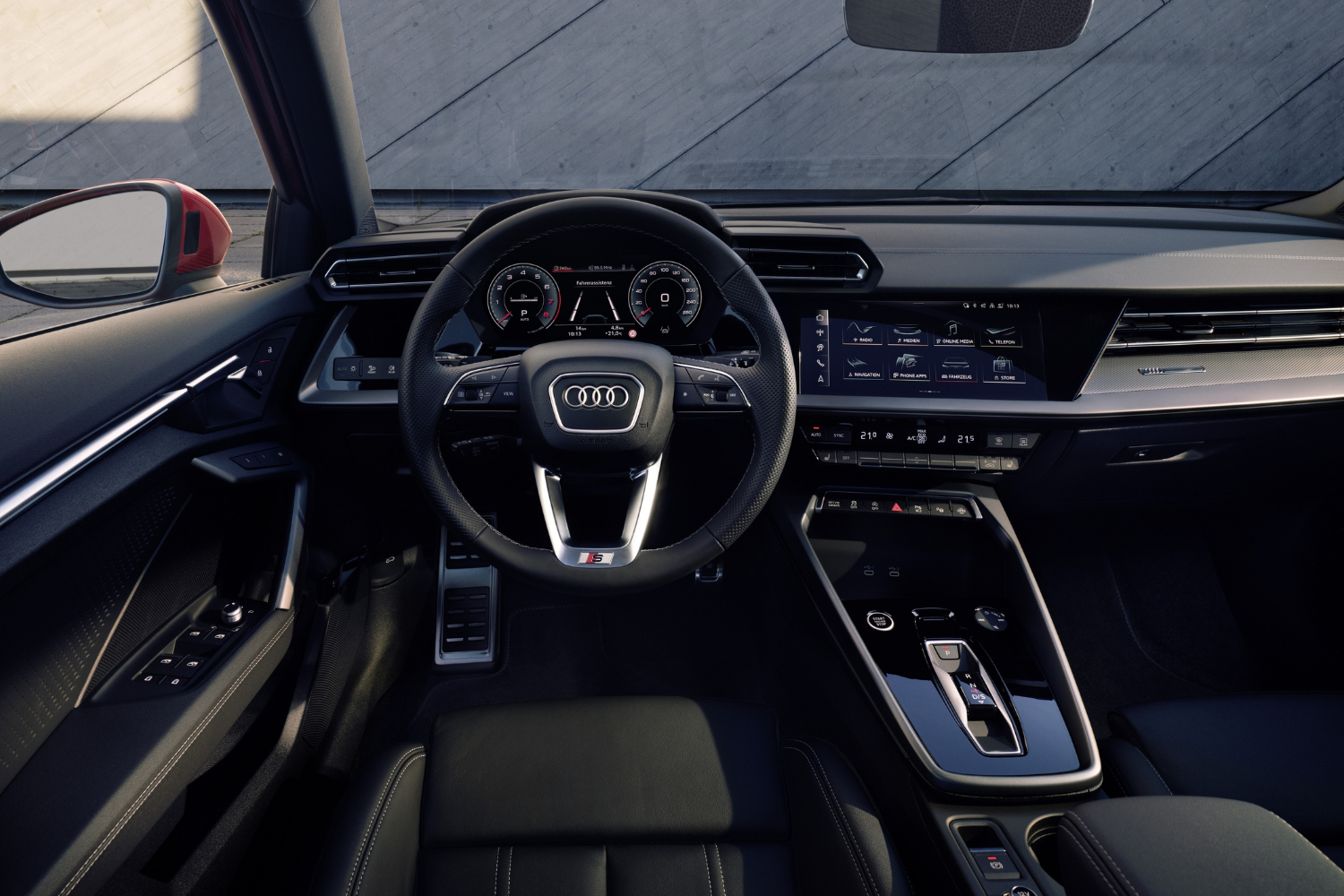 The newly updated Audi A3 Saloon 2024 black interior, steering wheel and two driver displays.