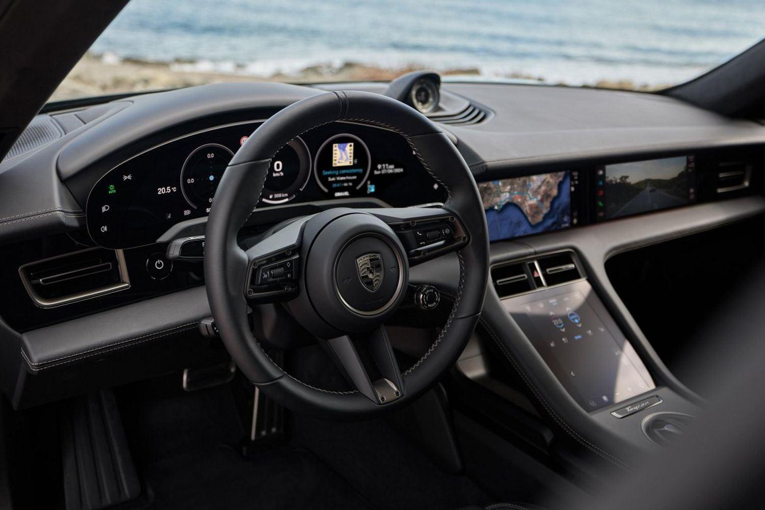 Close-up of the new Porsche Taycan interior, focus on steering wheel and central console