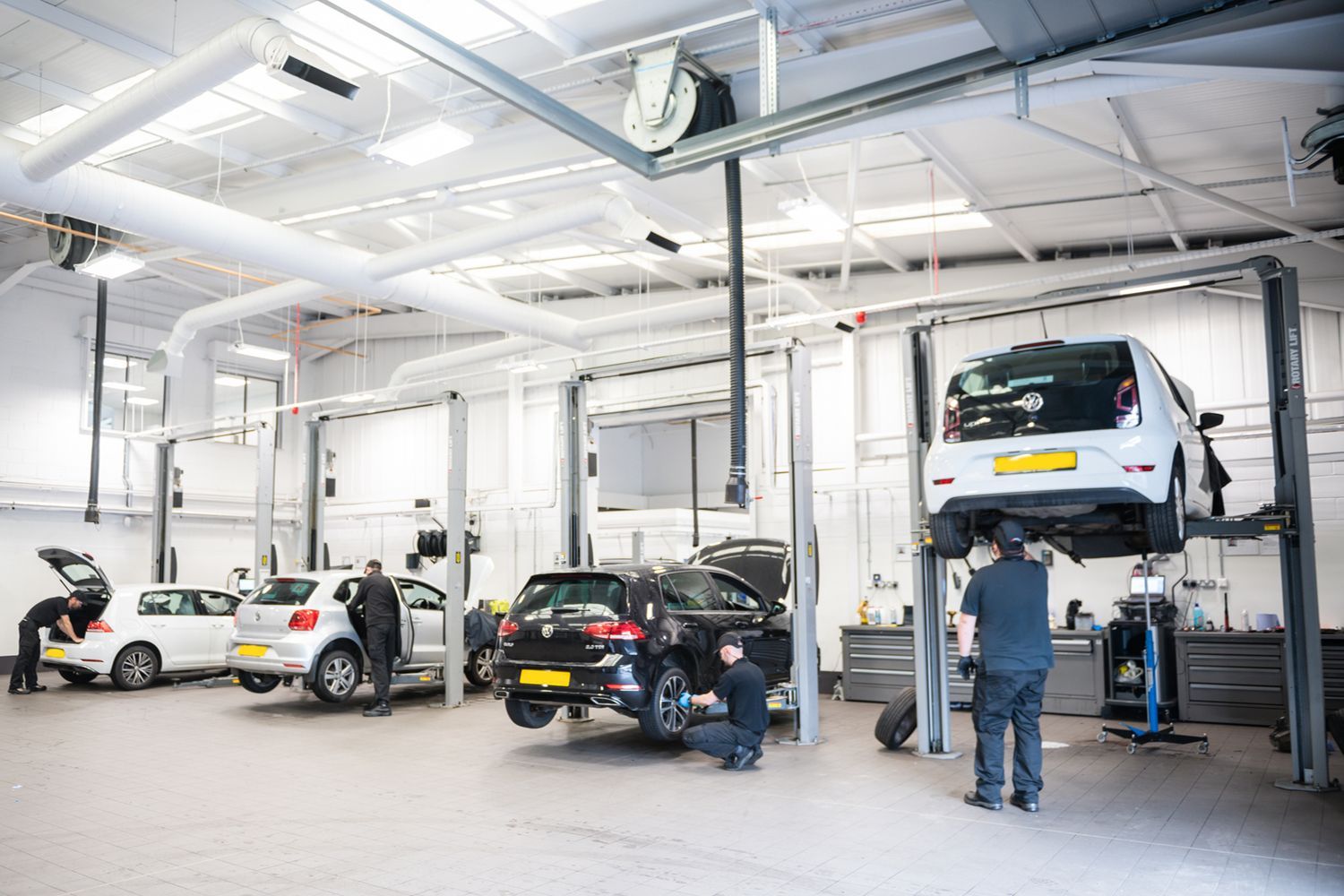 Four Volkswagen Service Specialists repair a range of Volkswagen vehicles (three Volkswagen Golfs and one Volkswagen Golf) at the Volkswagen Approved Accident Repair Centre, Agnew Volkswagen Mallusk