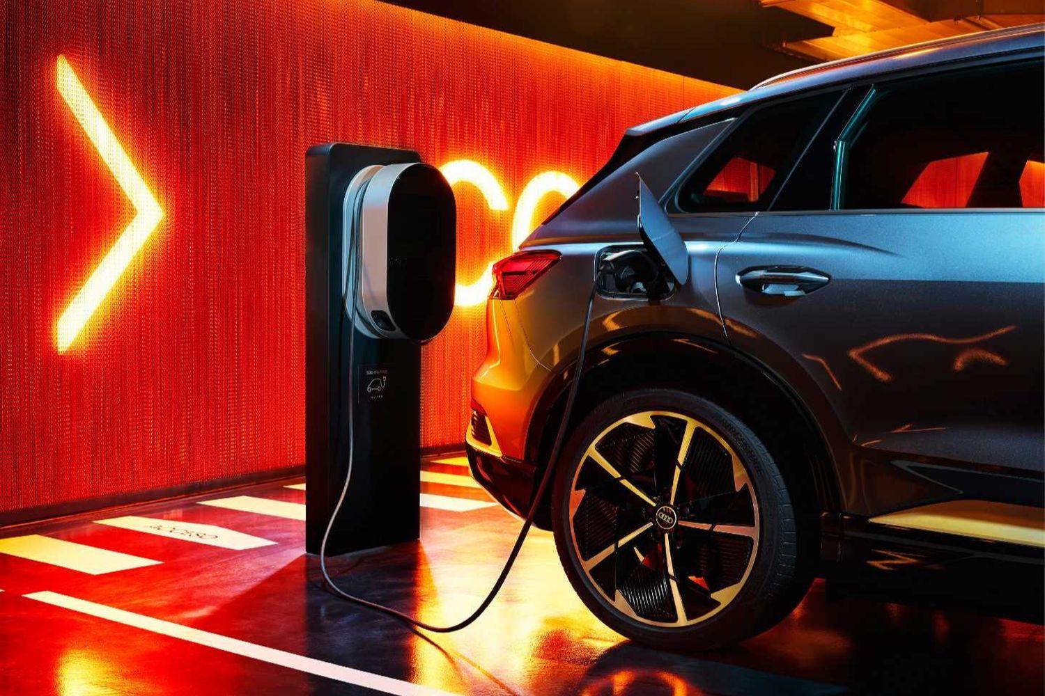 Motability car plugged into electric charging port in car park