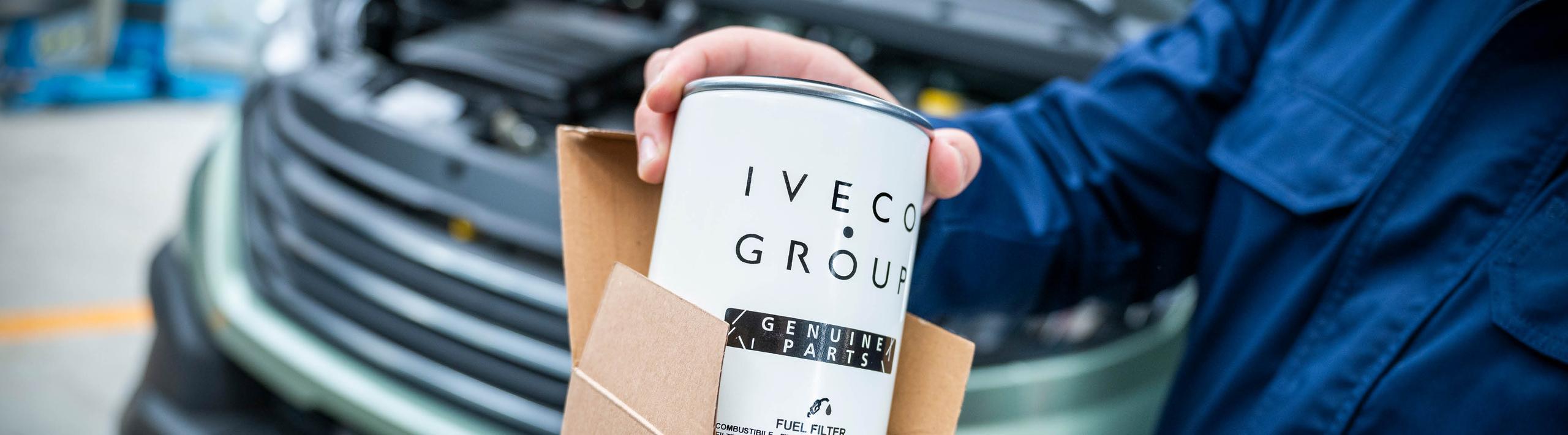 Person holding IVECO Fuel Filter in a workshop