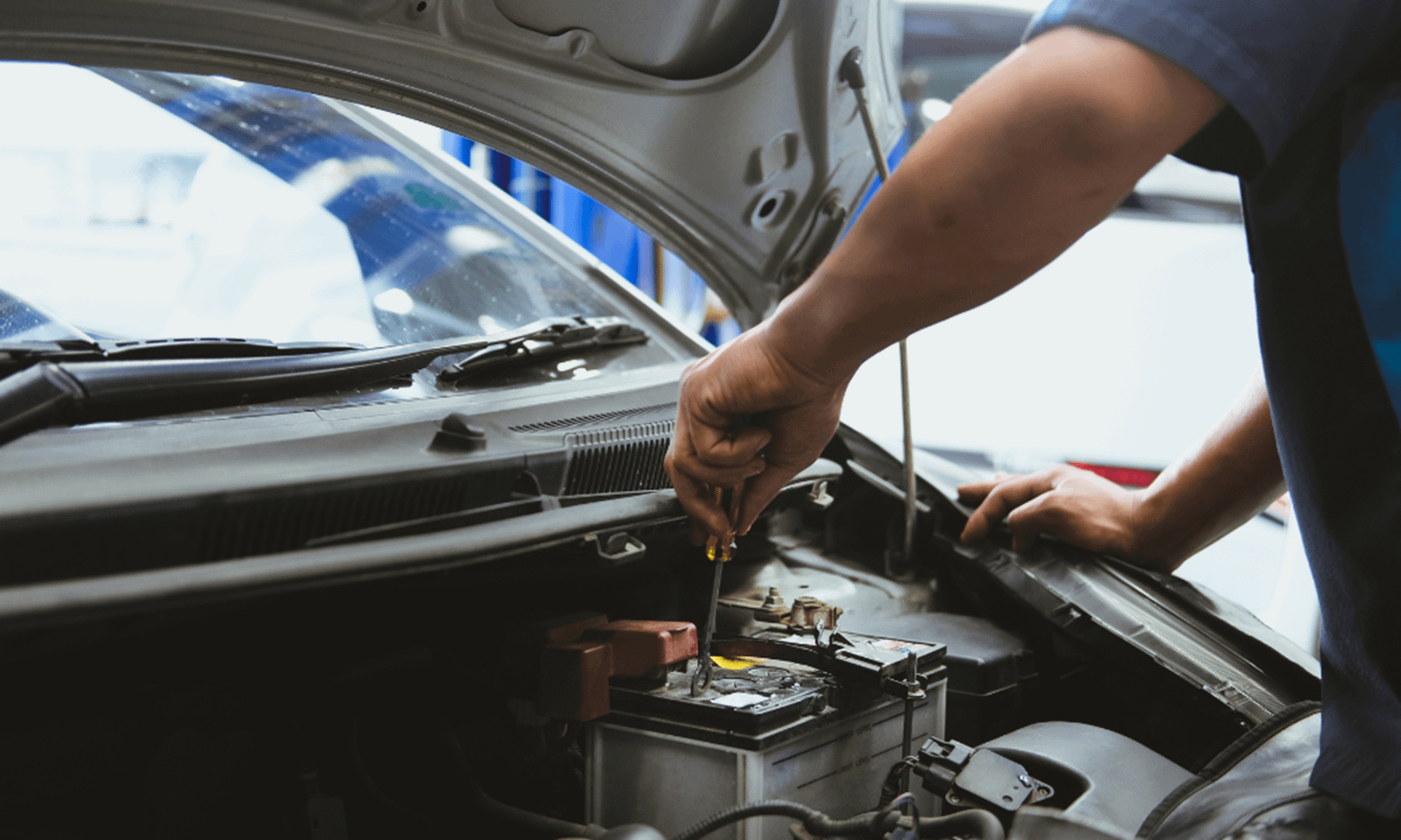 Car battery being fitted by a mechanic