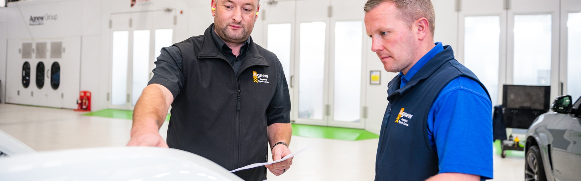 Two Agnew Repair Centre Specialist Technicians inspect vehicle for complicated structural repairs.