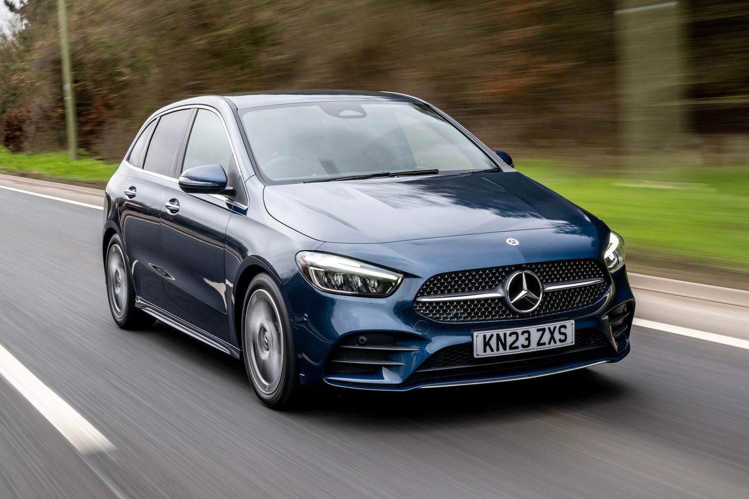 Blue B class side driving view