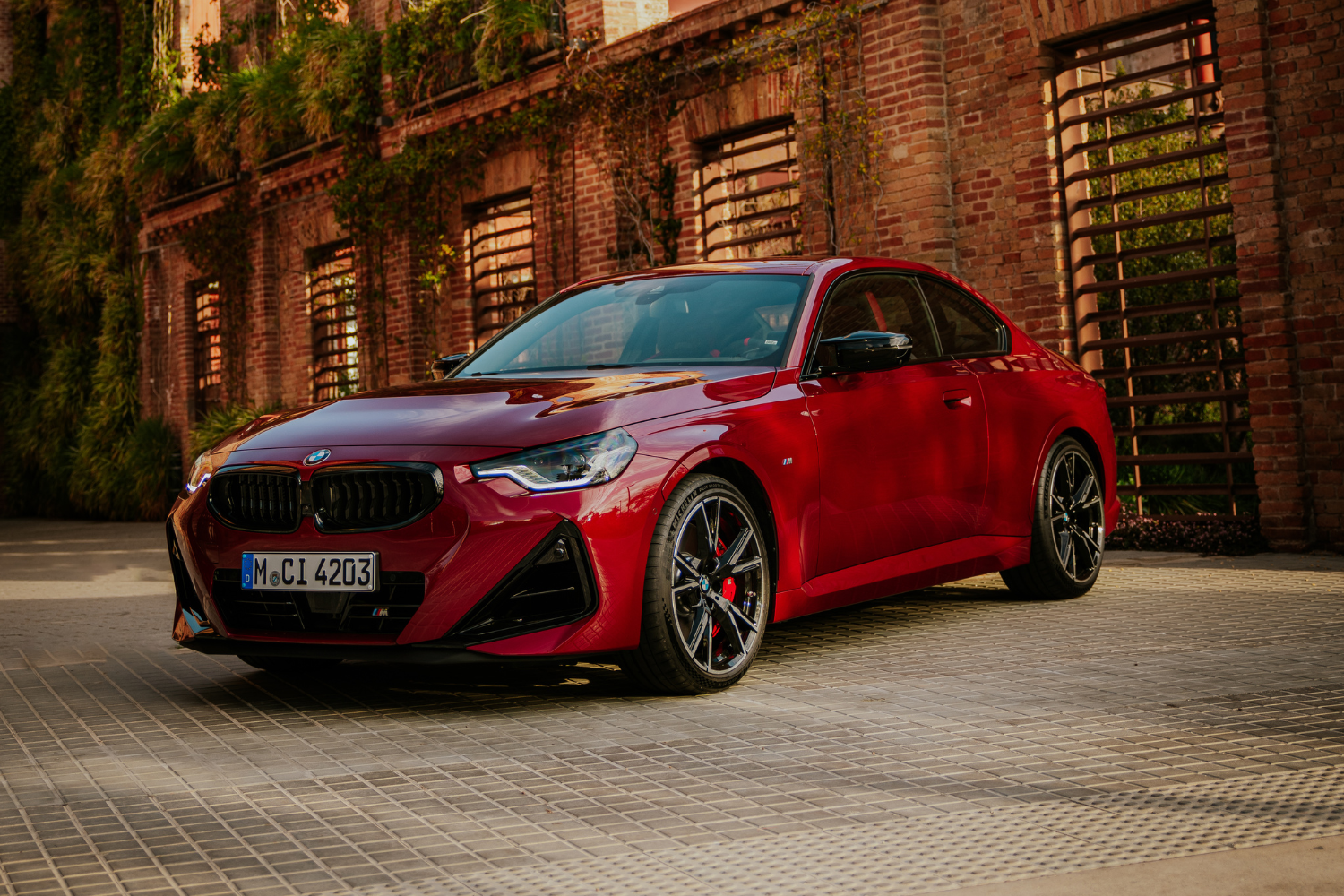 Front view of the newly updated 2024 BMW 2 Series Coupe in red.