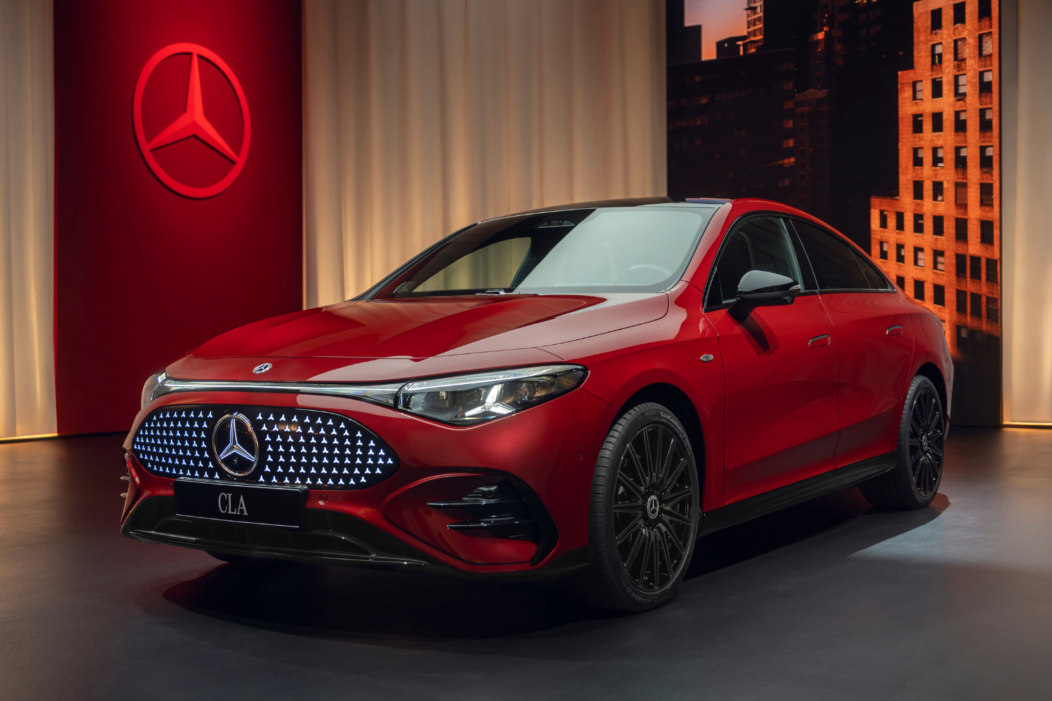 Side view of the new Mercedes-Benz CLA Electric Saloon in red metallic.