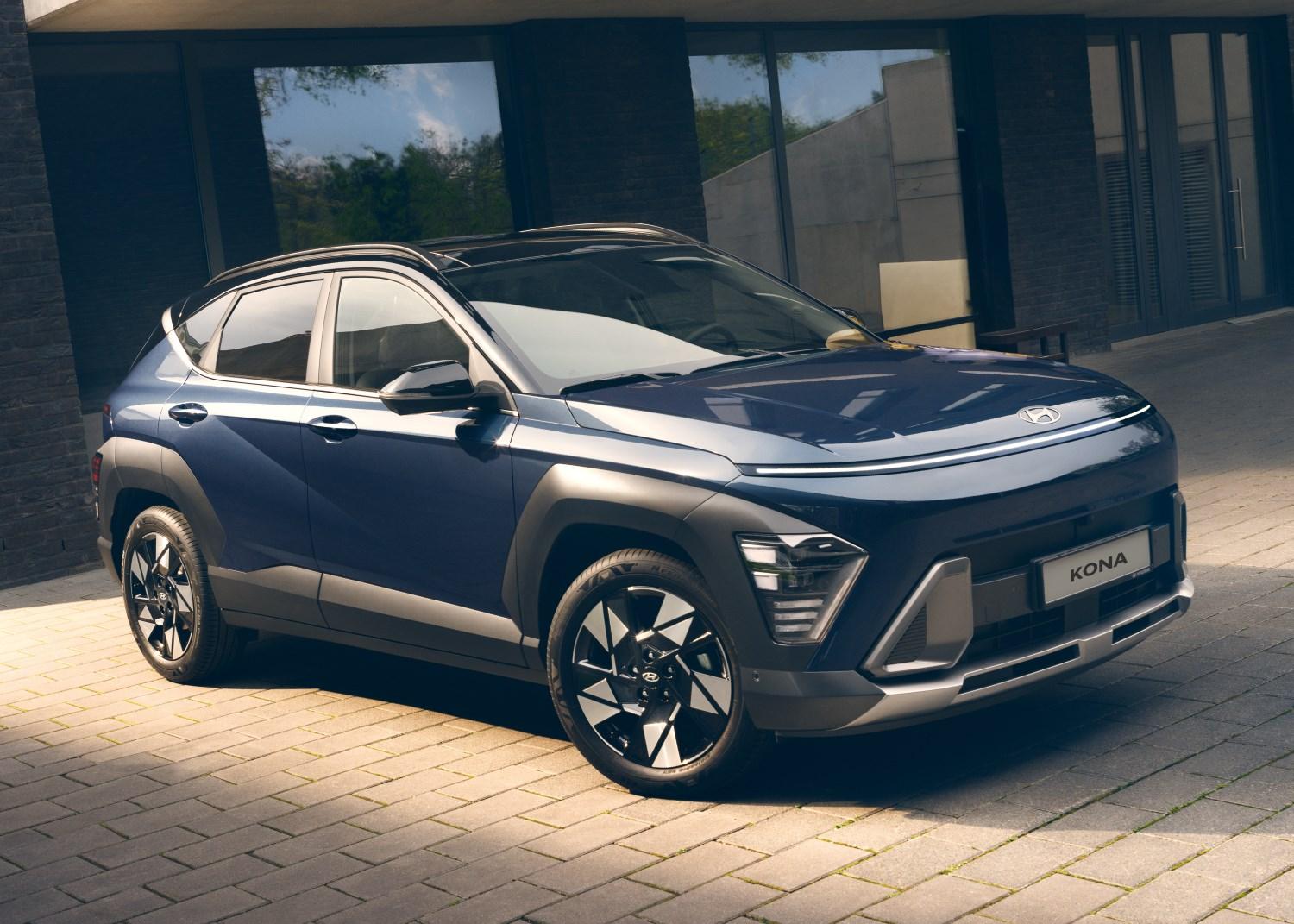 Three quarter right view of one Navy Blue Hyundai KONA car Parked outdoors in front of a building.