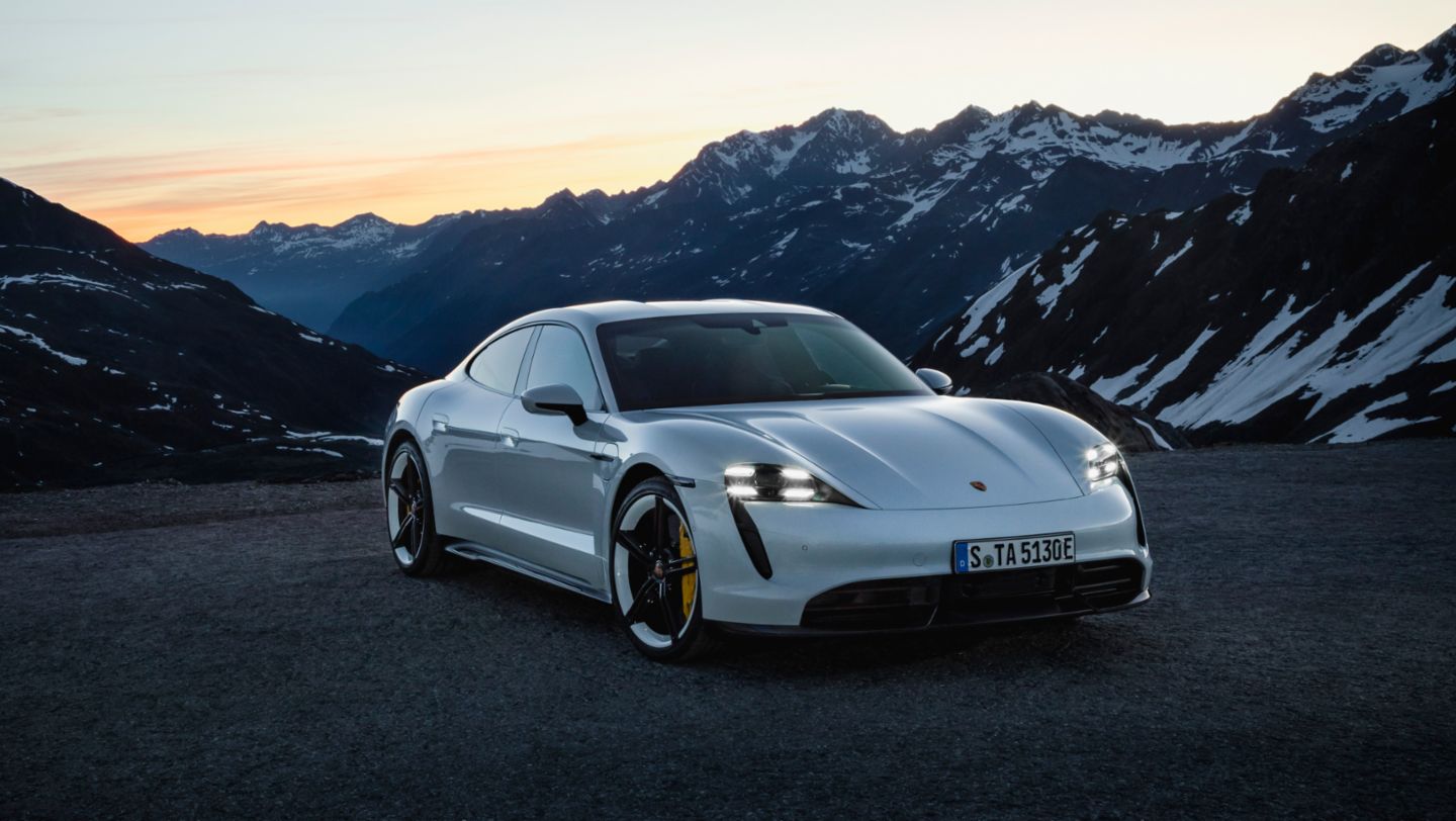 Electric and Hybrid Porsche Taycon parked on mountain