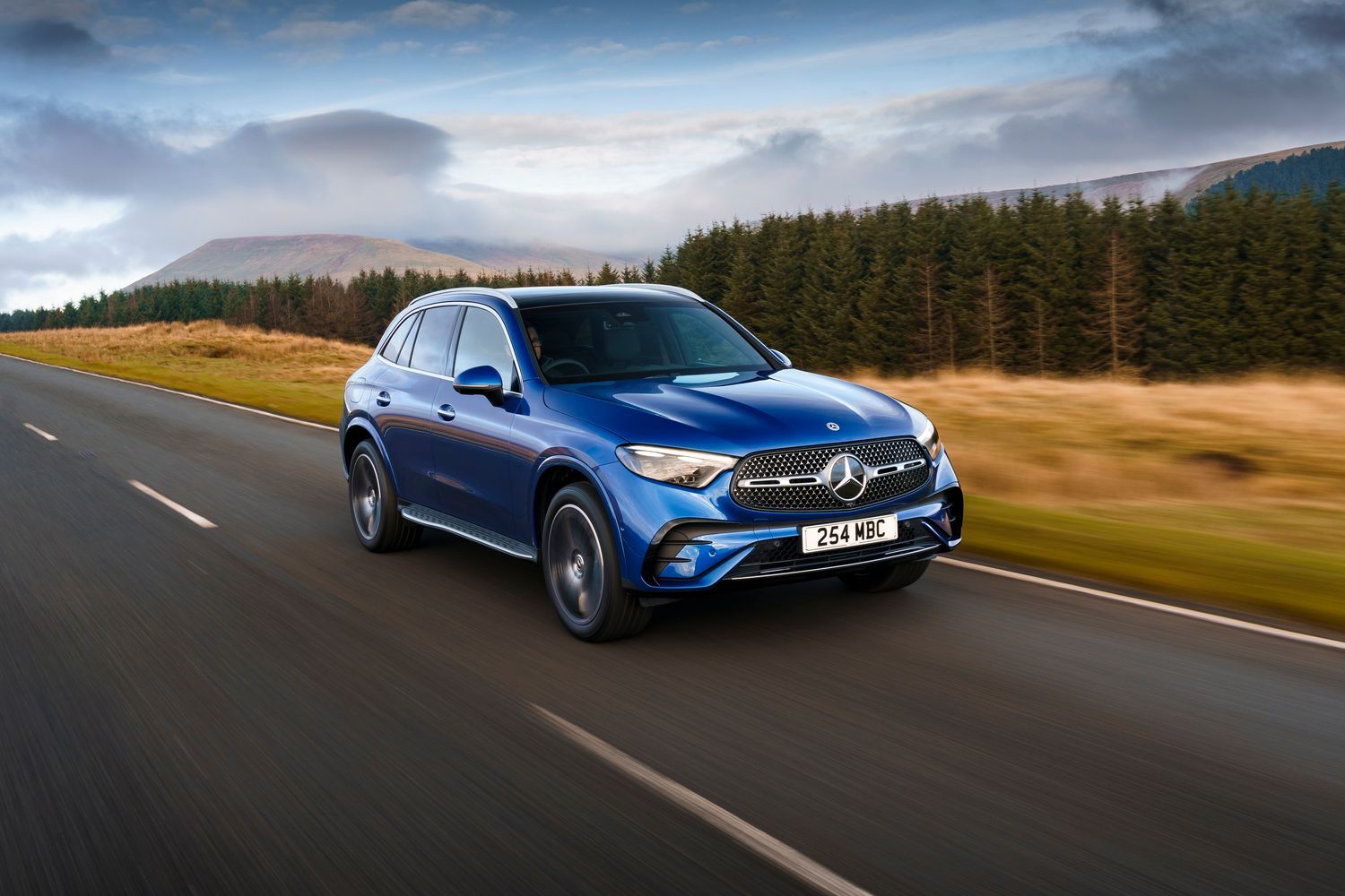 Side view of a blue Mercedes-Benz GLC driving.