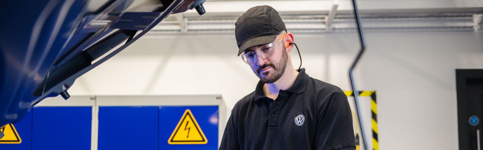 Volkswagen Technician inspects Electric Vehicle