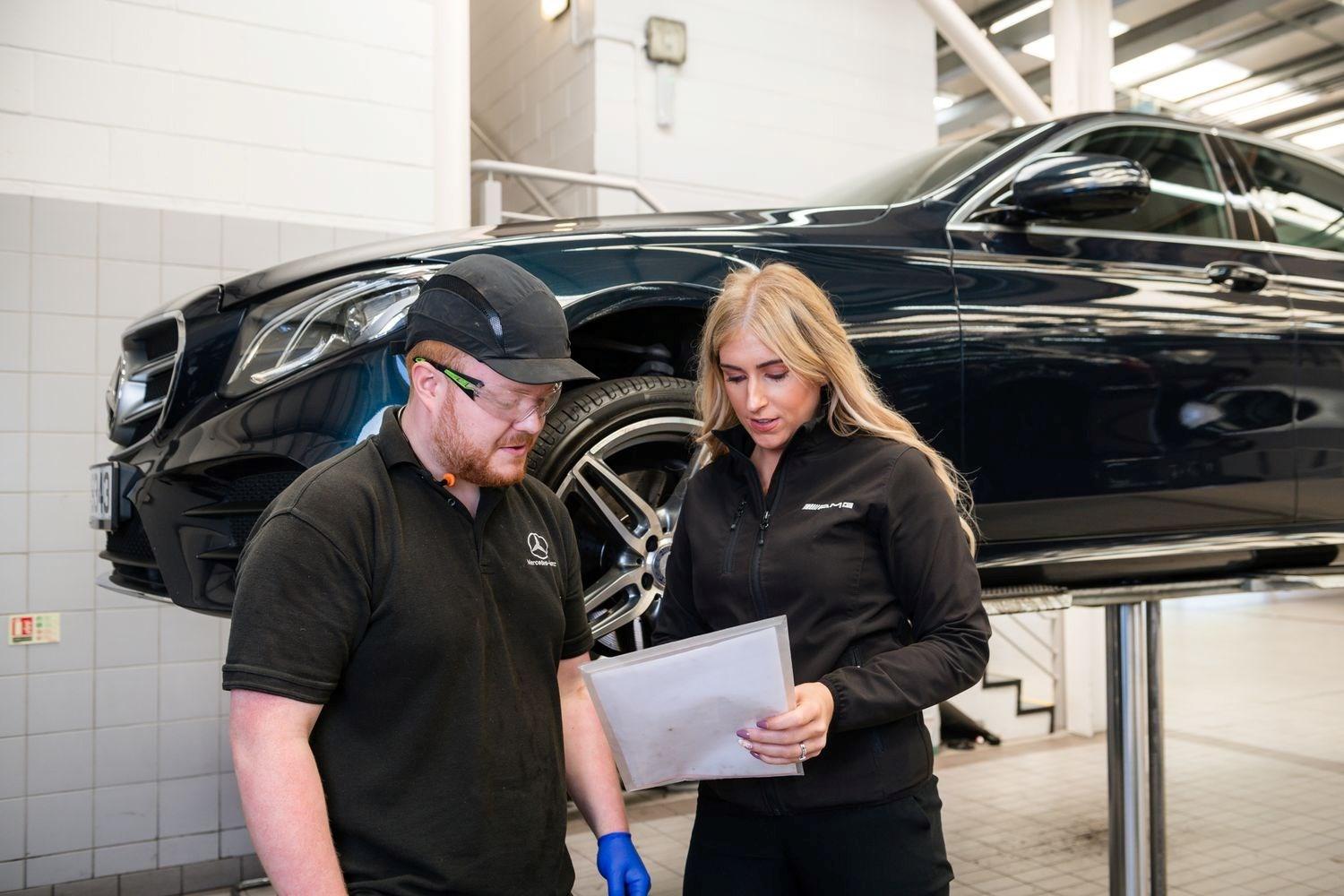 Mercedes-Benz Technicians discuss the list of items that need to be completed during routine maintenance at Mercedes-Benz of Portadown Repair Centre