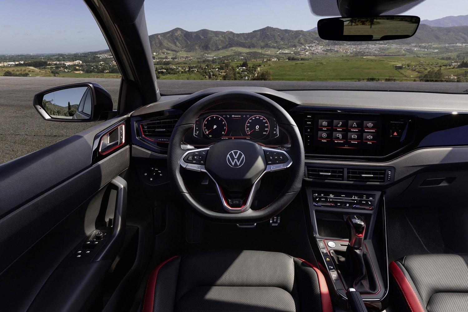 Interior view of the new Volkswagen Polo in white, close-up of the steering wheel and infotainment system