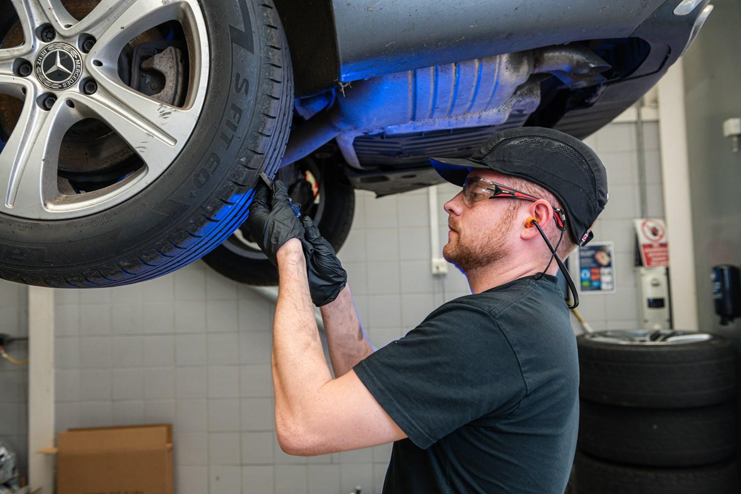 Mercedes-Benz mechanic checking wheels